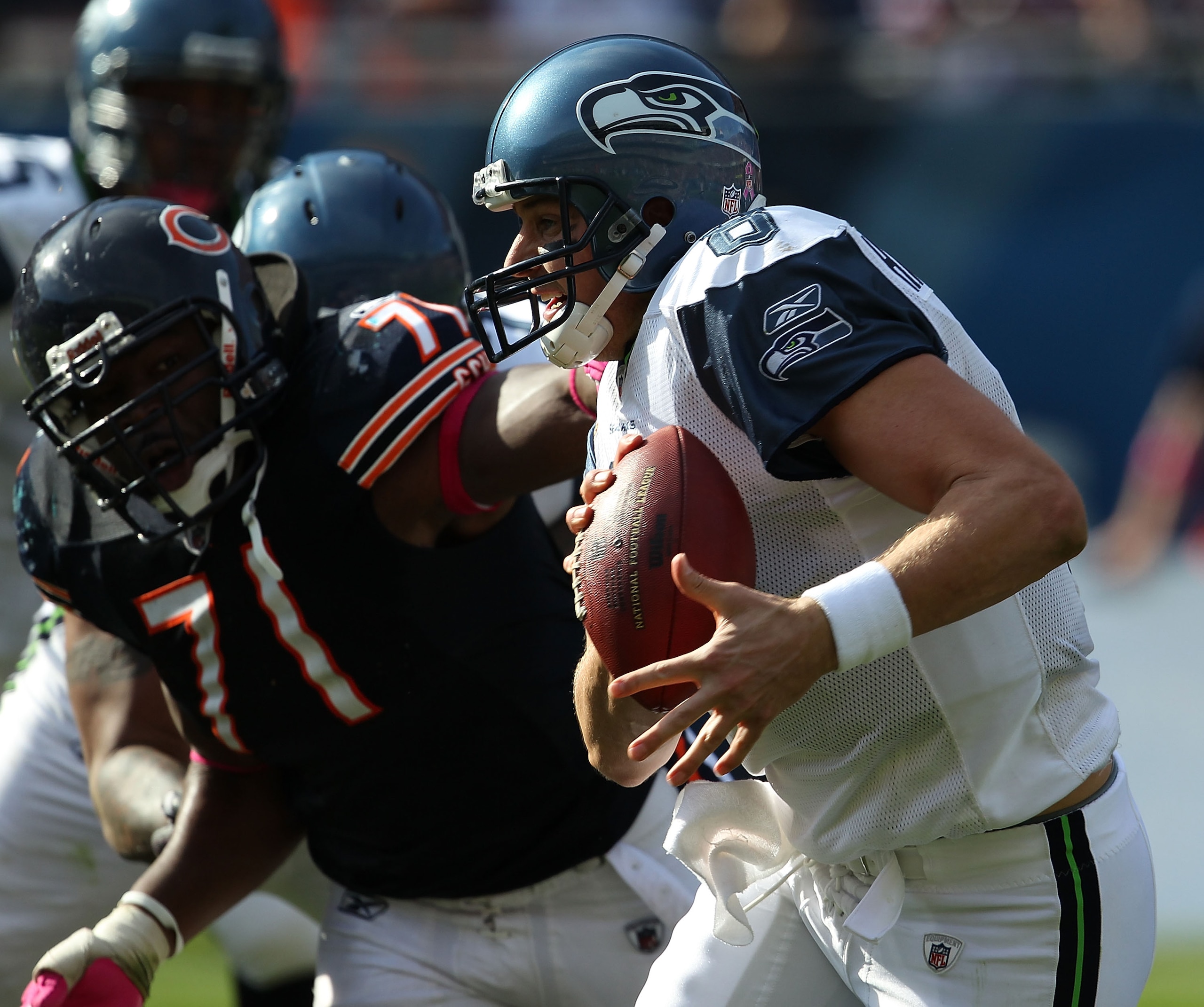 CHICAGO - OCTOBER 17: Matt Hasselbeck #8 of the Seattle Seahawks runs past Israel Idonije #71 of the Chicago Bears at Soldier Field on October 17, 2010 in Chicago, Illinois. The Seahawks defeated the Bears 23-20. (Photo by Jonathan Daniel/Getty Images)