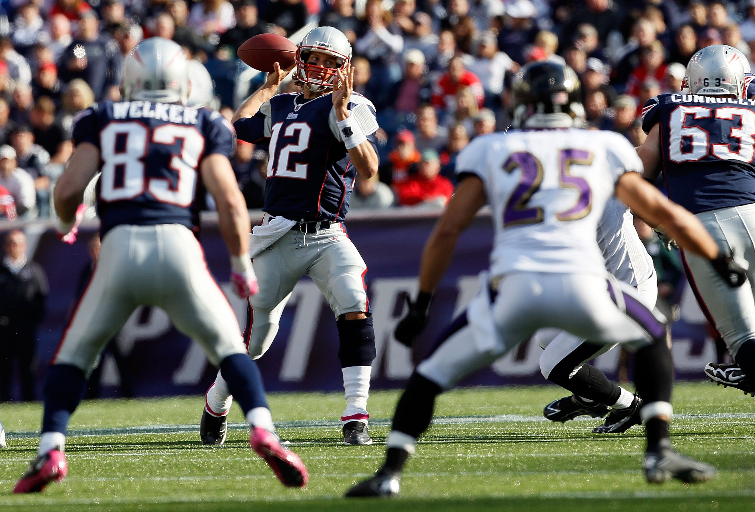 FOXBORO, MA - OCTOBER 17:  Tom Brady #12 of the New England Patriots looks for an open man during a game against the Baltimore Ravens at Gillette Stadium in the second half on October 17, 2010 in Foxboro, Massachusetts. (Photo by Jim Rogash/Getty Images)