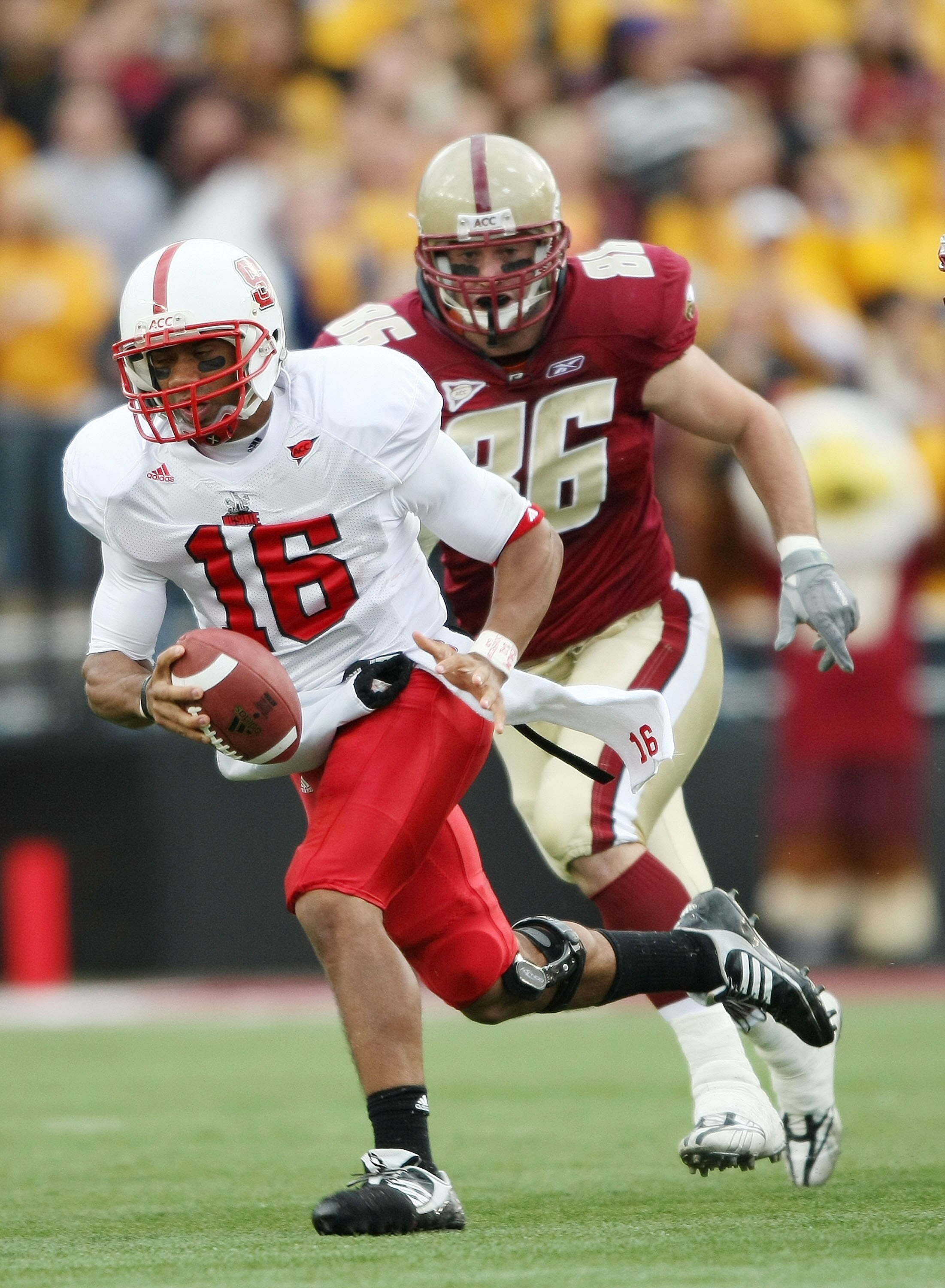 CHESTNUT HILL, MA - OCTOBER 17:  Russell Wilson #16 of the North Carolina State Wolf Pack carries the ball as Jim Ramella #86 of the Boston College Eagles pressures on October 17, 2009 at Alumni Stadium in Chestnut Hill, Massachusetts.  (Photo by Elsa/Get