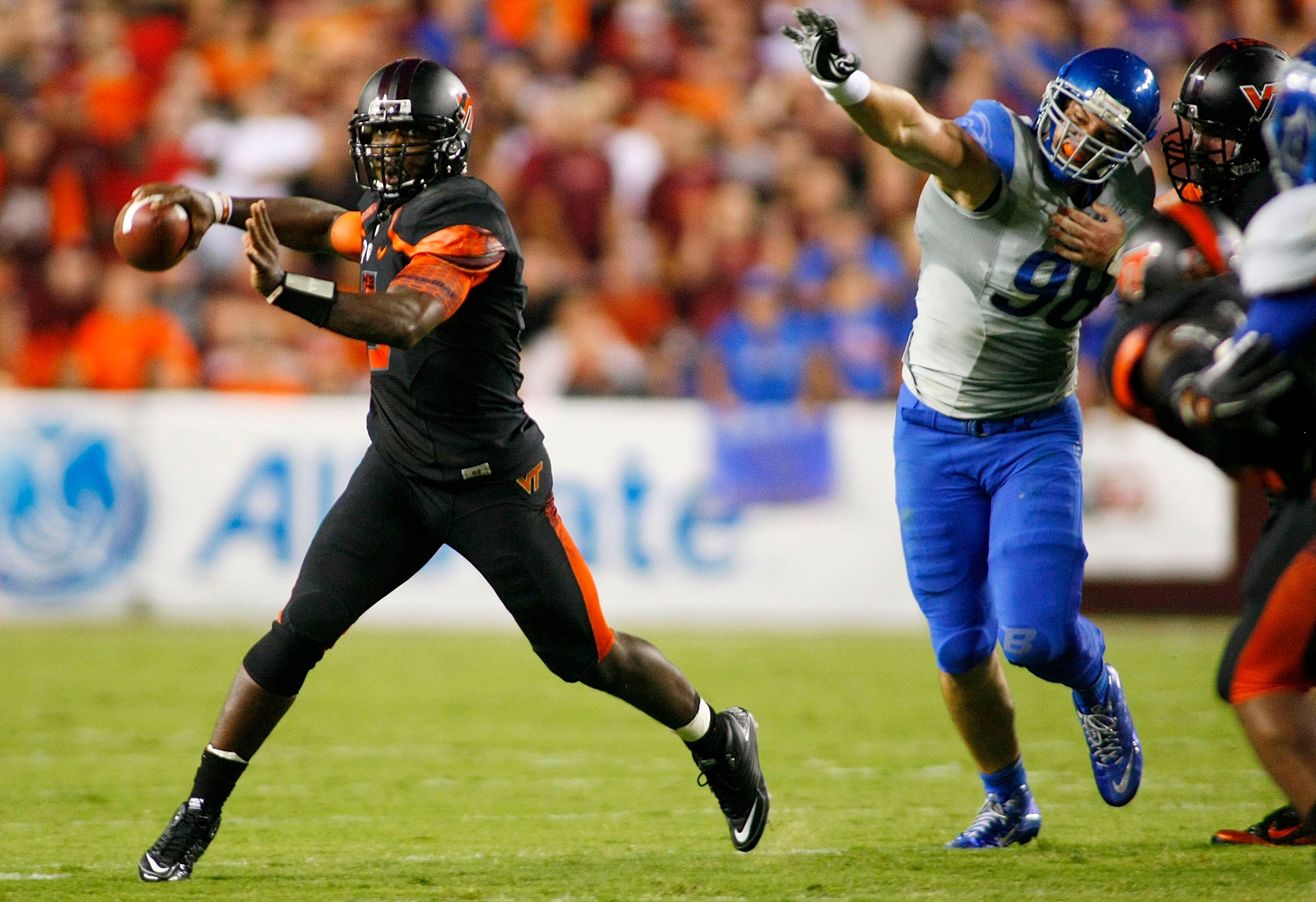 LANDOVER, MD - SEPTEMBER 06:  Quarterback #5 Tyrod Taylor of the Virginia Tech Hokies throws as defensive end #98 Ryan Winterswyk of the Boise State Broncos chases at FedExField on September 6, 2010 in Landover, Maryland.  (Photo by Geoff Burke/Getty Imag