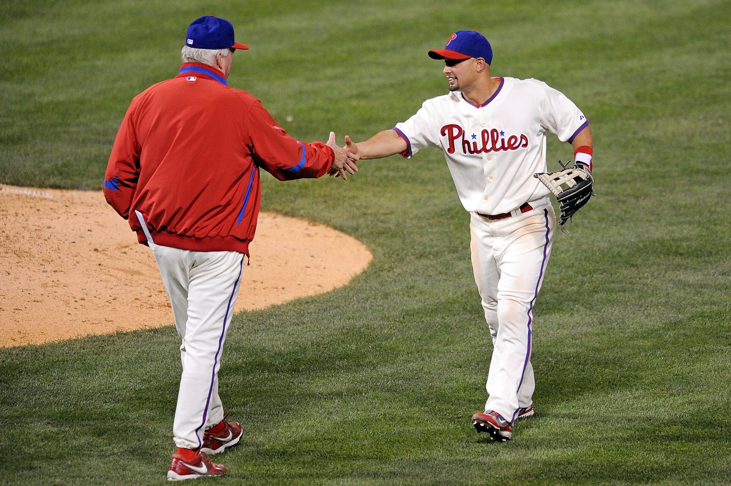 PHILADELPHIA - OCTOBER 10:  Manager Charlie Manuel #41 and Shane Victorino  #8 of the Philadelphia Phillies celebrate after their 8-5 win against the Los Angeles Dodgers in Game Two of the National League Championship Series during the 2008 MLB playoffs o