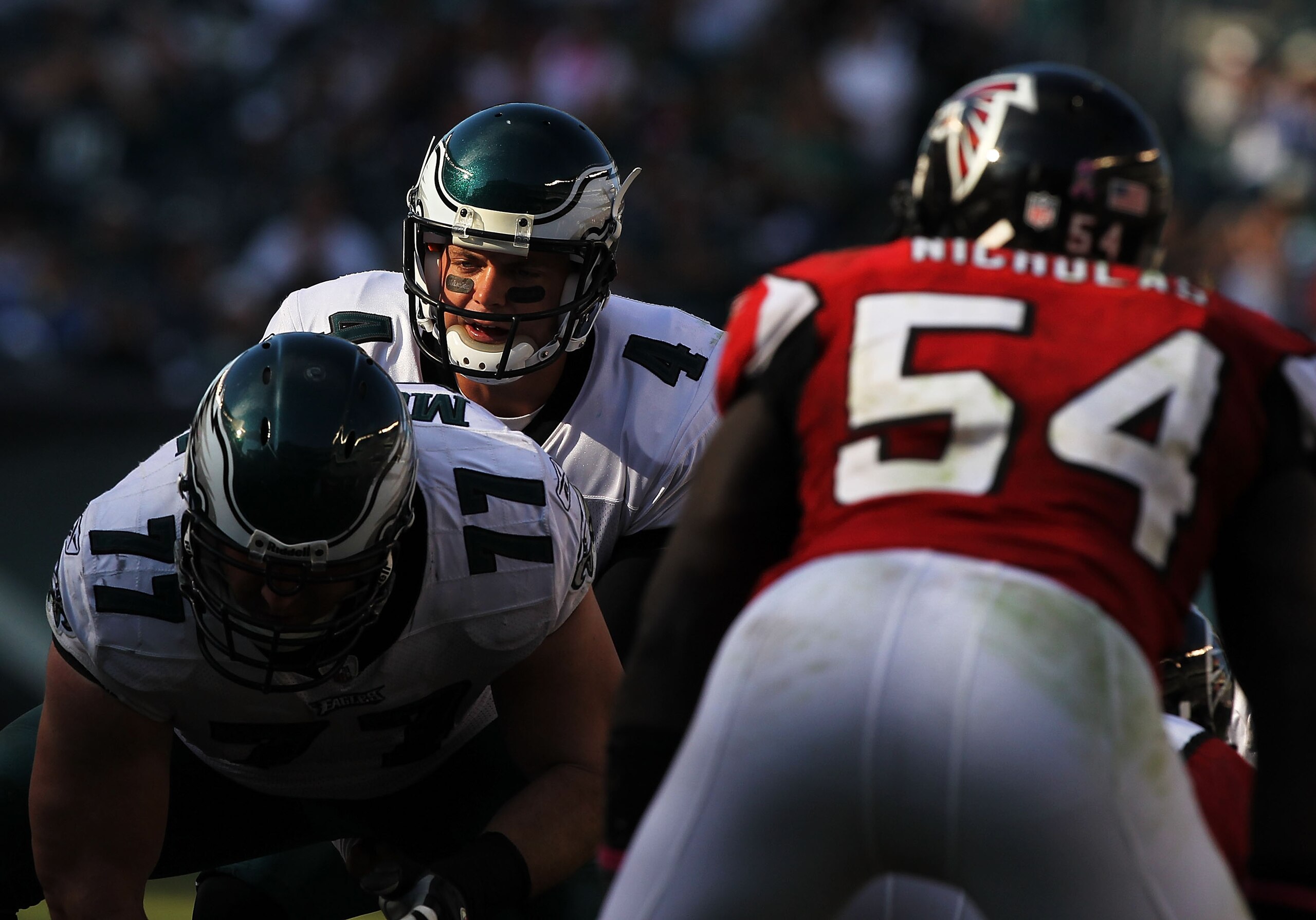 PHILADELPHIA - OCTOBER 17:  Kevin Kolb #4 of the Philadelphia Eagles lines up under center Mike McGlynn #77 as Stephen Nicholas #54 of the Atlanta Falcons defends during their game at Lincoln Financial Field on October 17, 2010 in Philadelphia, Pennsylvan