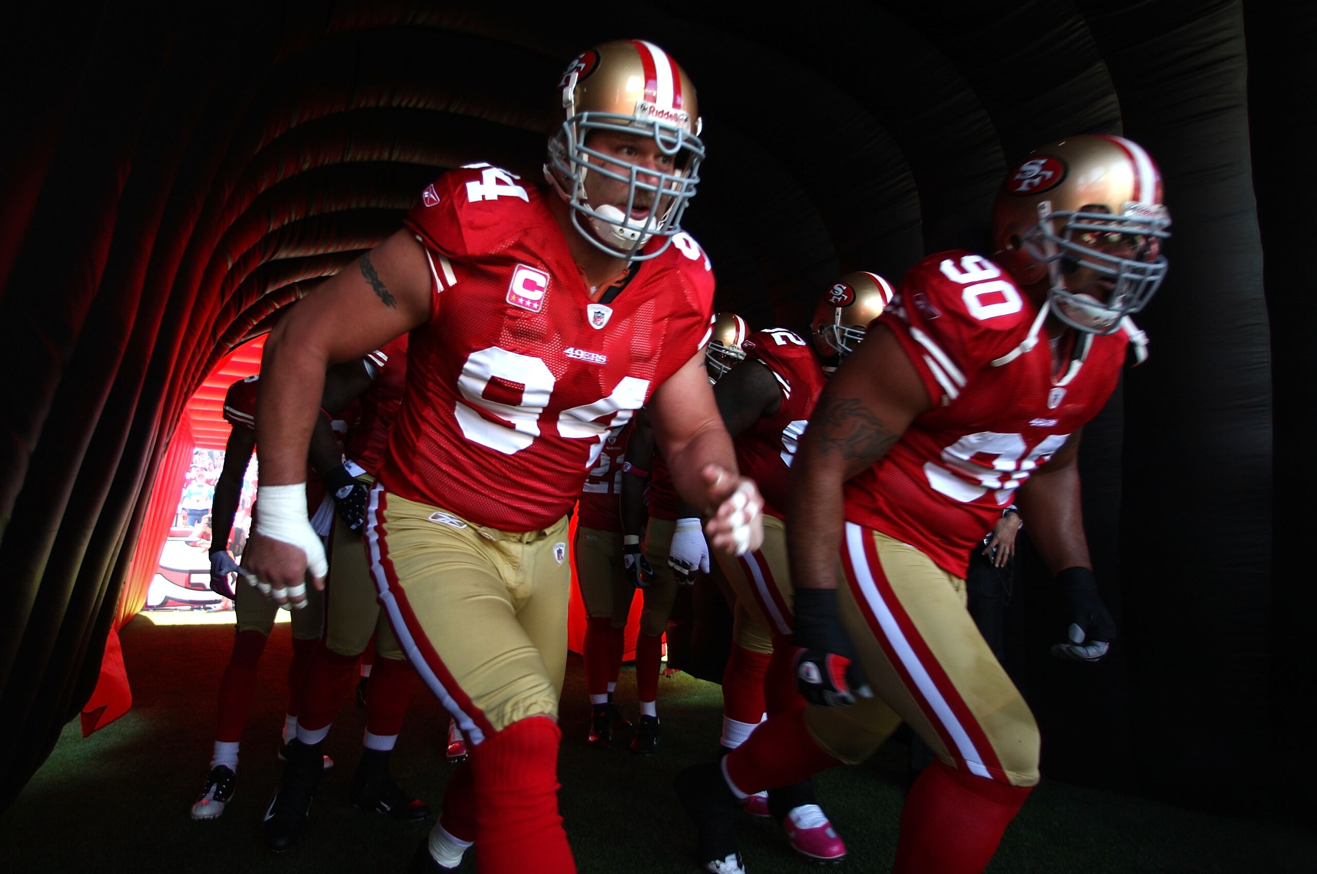SAN FRANCISCO - OCTOBER 04:  Justin Smith #94 and Isaac Sopoaga #90 of the San Francisco 49ers enter the field against the St. Louis Rams during an NFL game on October 4, 2009 at Candlestick Park in San Francisco, California.  (Photo by Jed Jacobsohn/Gett