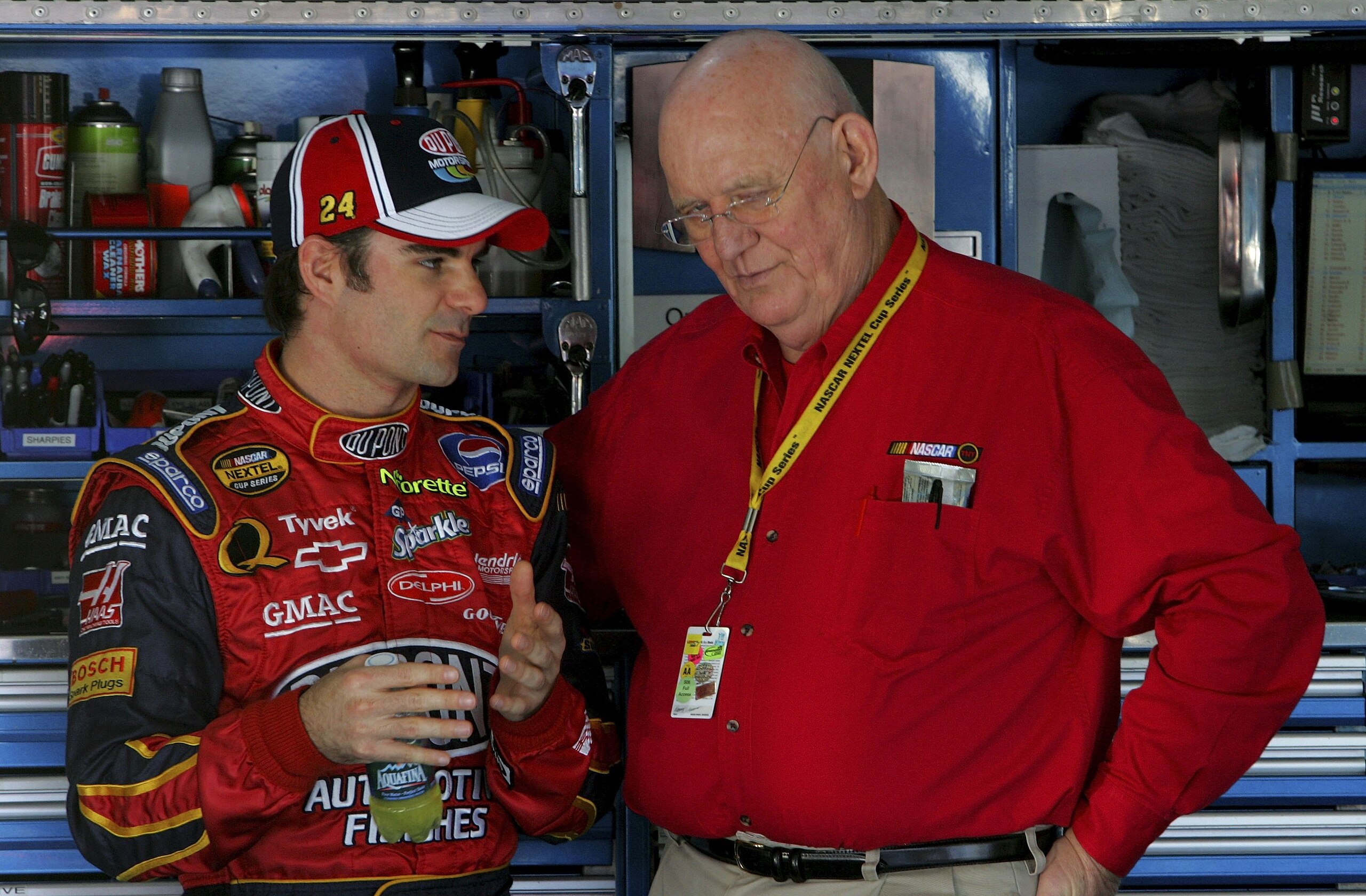 CONCORD, NC - OCTOBER 13: Jeff Gordon, driver of the #24 DuPont Chevrolet, talks with TV Analyst Benny Parsons, in the garage, during practice for the NASCAR Nextel Cup Series Bank of America 500 on October 13, 2006 at Lowe's Motor Speedway in Concord, N CONCORD, NC - OCTOBER 13: Jeff Gordon, driver of the #24 DuPont Chevrolet, talks with TV Analyst Benny Parsons, in the garage, during practice for the NASCAR Nextel Cup Series Bank of America 500 on October 13, 2006 at Lowe's Motor Speedway in Concord, N
