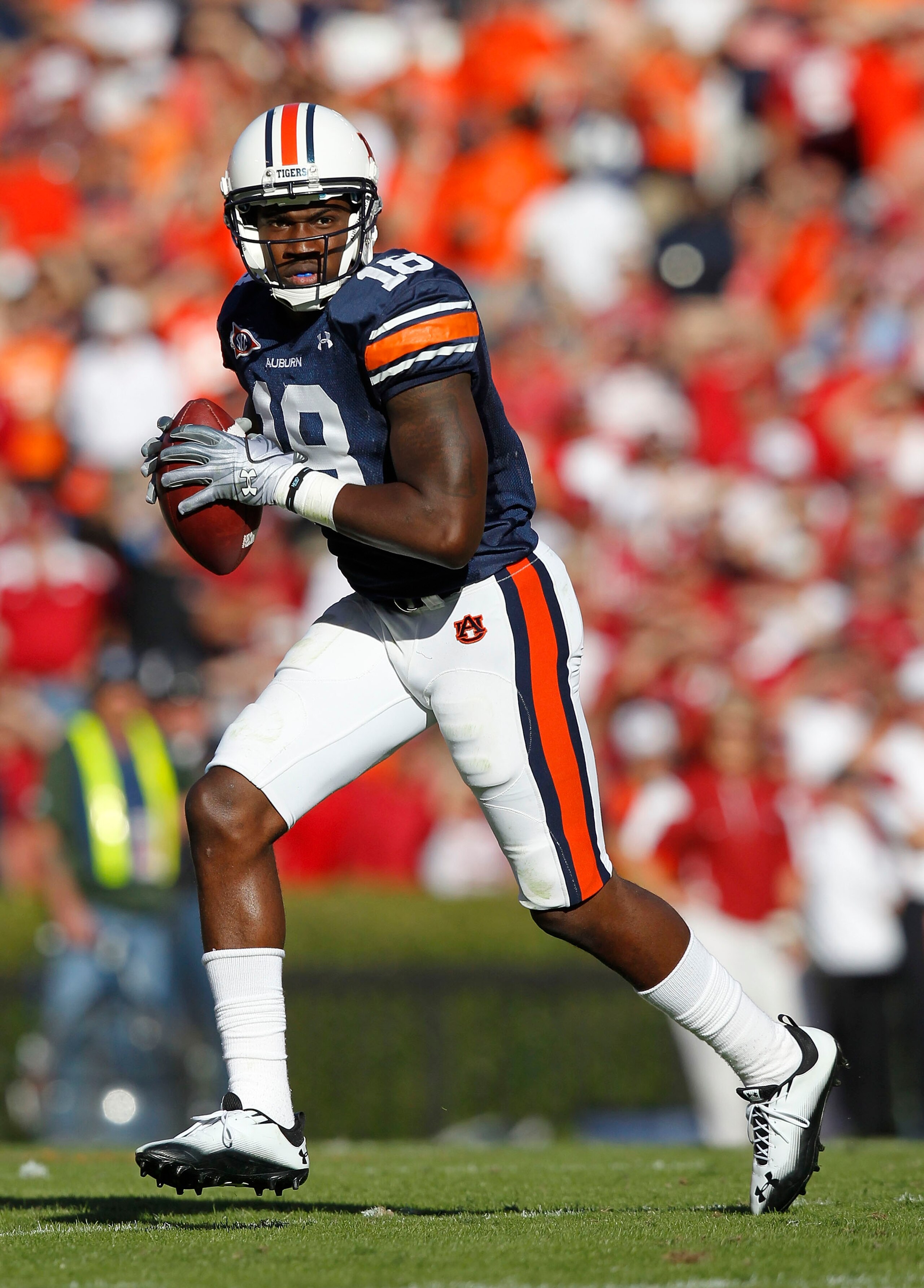AUBURN - OCTOBER 16:  Wide receiver Kodi Burns #18 of the Auburn Tigers rolls out and looks downfield for a passing target during the game against the Arkansas Razorbacks at Jordan-Hare Stadium on October 16, 2010 in Auburn, Alabama.  (Photo by Mike Zarri