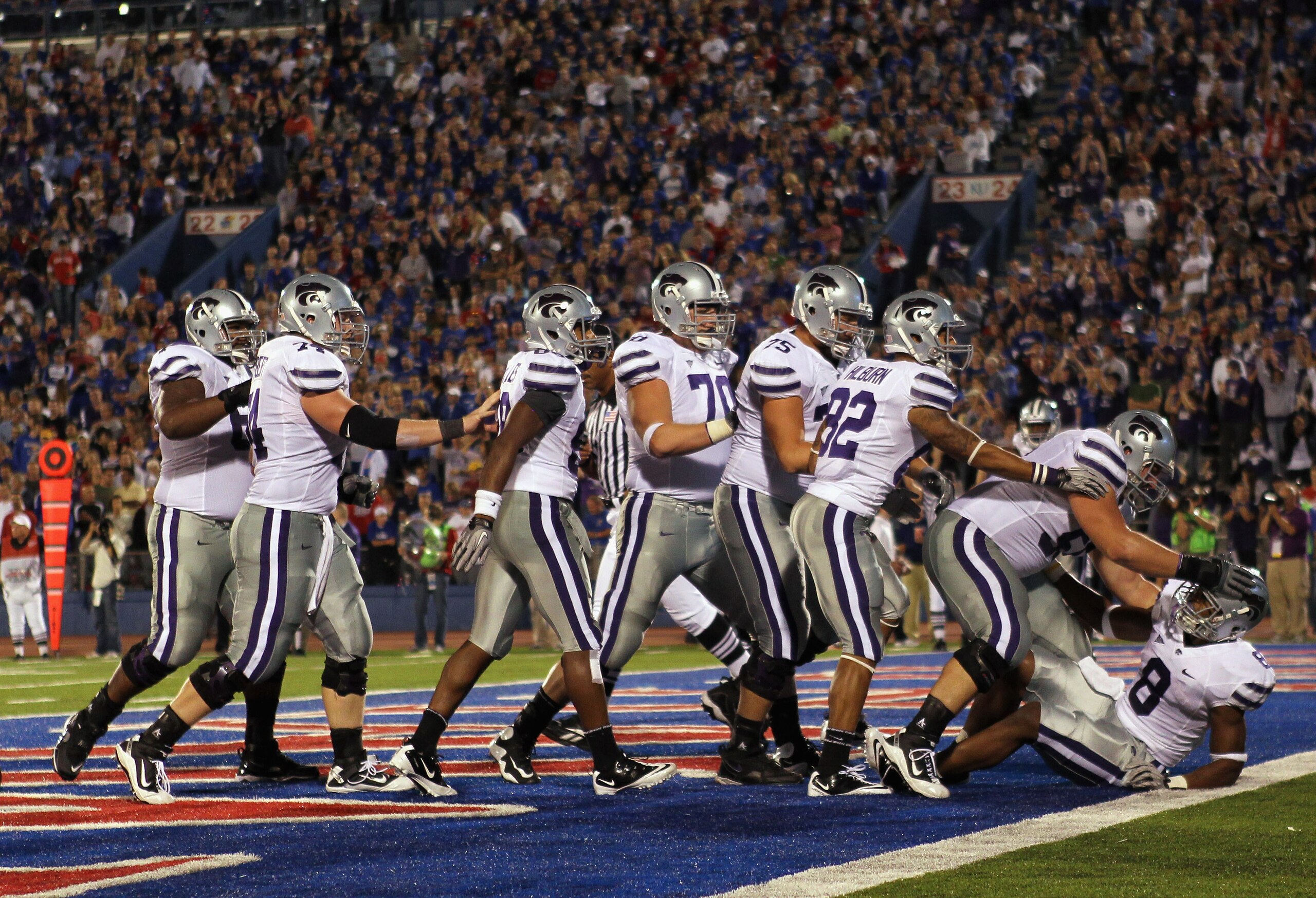 LAWRENCE, KS - OCTOBER 14: Daniel Thomas #8 of the Kansas State Wildcats is congratulated by teammates after scoring a touchdown during the game against the Kansas Jayhawks on October 14, 2010 at Memorial Stadium in Lawrence, Kansas. (Photo by Jamie Squ LAWRENCE, KS - OCTOBER 14: Daniel Thomas #8 of the Kansas State Wildcats is congratulated by teammates after scoring a touchdown during the game against the Kansas Jayhawks on October 14, 2010 at Memorial Stadium in Lawrence, Kansas. (Photo by Jamie Squ