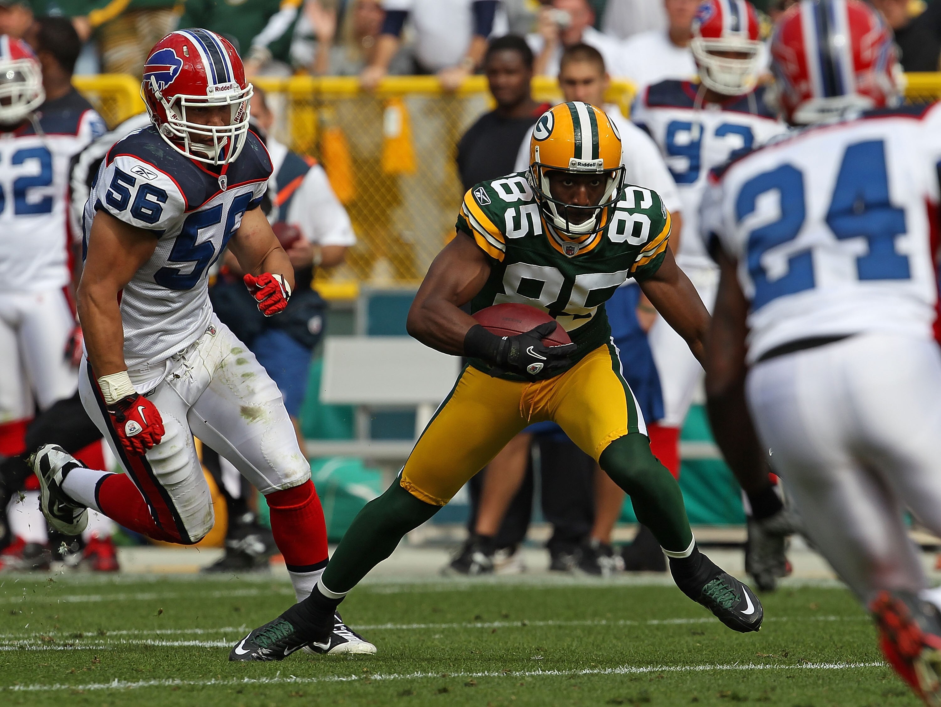 GREEN BAY, WI - SEPTEMBER 19: Greg Jennings #85 of the Green Bay Packers moves between Keith Ellison #56 and Terrence McGee #24 of the Buffalo Bills after catching a pass at Lambeau Field on September 19, 2010 in Green Bay, Wisconsin. The Packers defeated