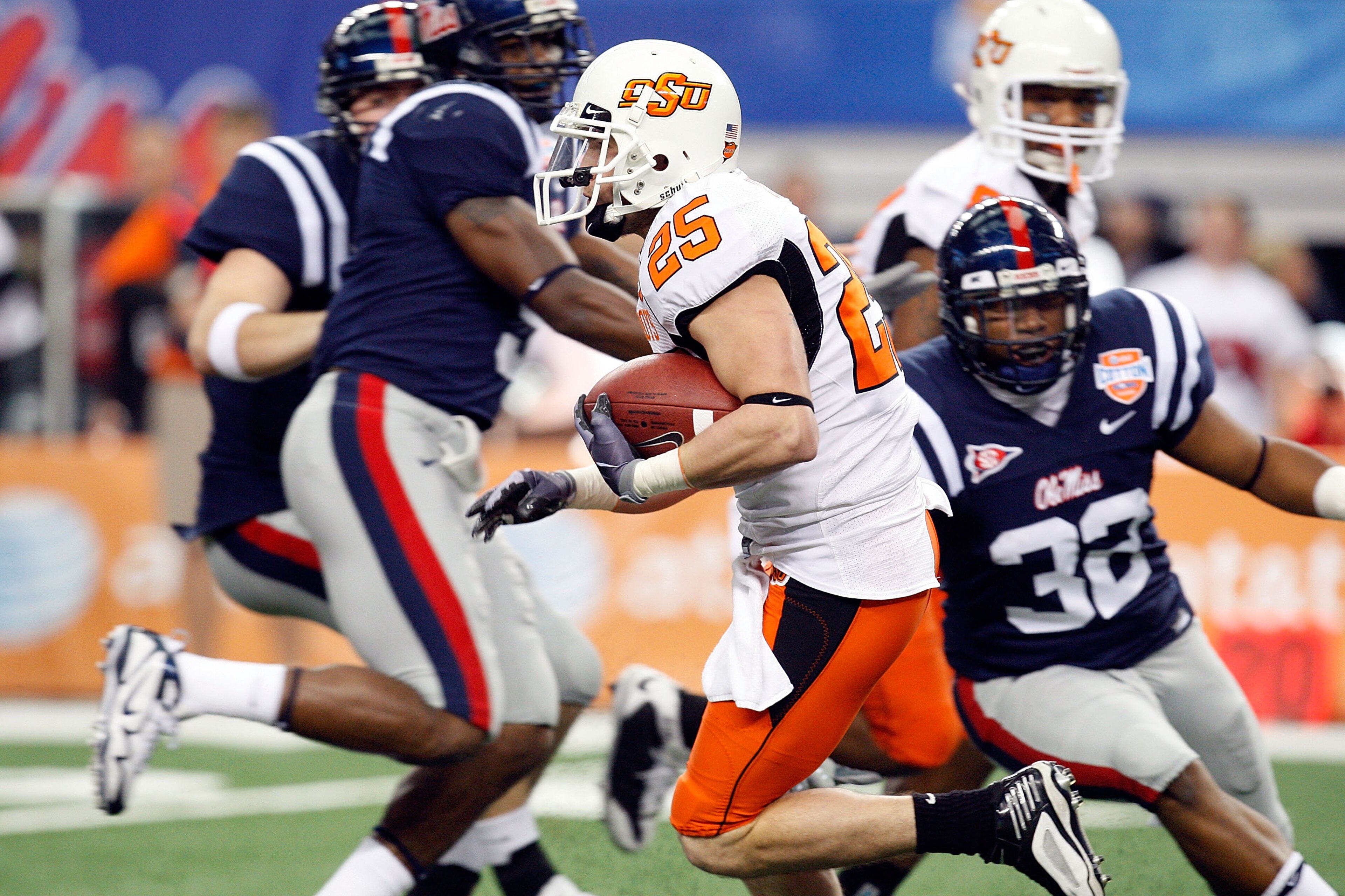 ARLINGTON, TX - JANUARY 02:  Josh Cooper #25 of the Oklahoma State Cowboys runs the ball against the Mississippi Rebels during the AT&T Cotton Bowl on January 2, 2010 at Cowboys Stadium in Arlington, Texas.  (Photo by Ronald Martinez/Getty Images)