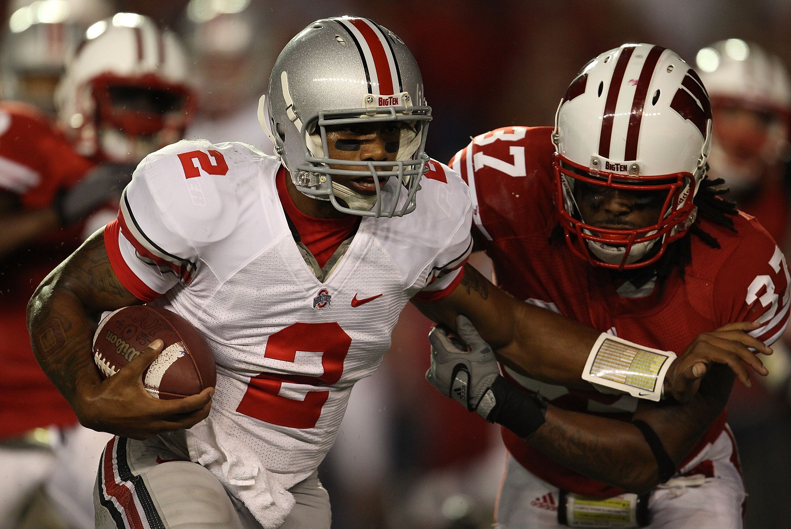 MADISON, WI - OCTOBER 16: Terrelle Pryor #2 of the Ohio State Buckeyes rushes against Kevin Claxton #37 of the Wisconsin Badgers at Camp Randall Stadium on October 16, 2010 in Madison, Wisconsin. Wisconsin defeated Ohio State 31-18. (Photo by Jonathan Dan