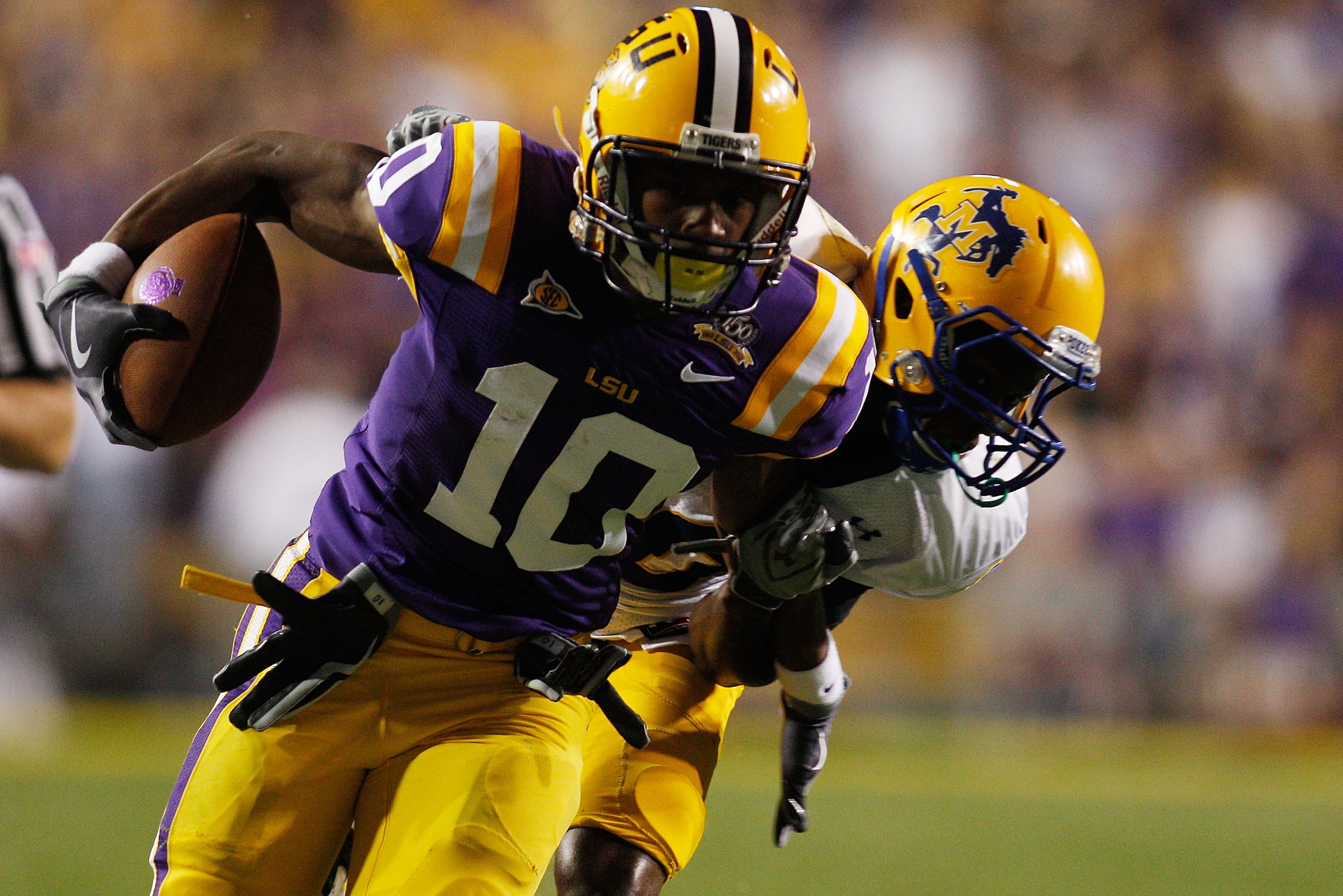 BATON ROUGE, LA - OCTOBER 16:  Russell Shepard #10 of the Louisiana State University Tigers is tackled by London Durham #10 of the McNeese State Cowboys at Tiger Stadium on October 16, 2010 in Baton Rouge, Louisiana.  The Tigers defeated the Cowboys 32-10