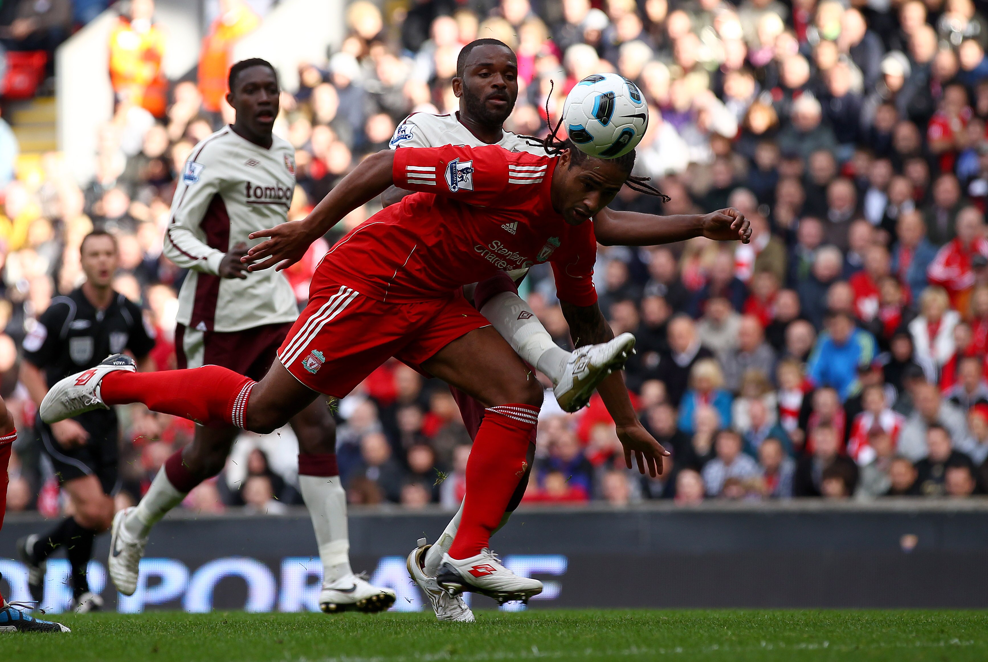 LIVERPOOL, ENGLAND - SEPTEMBER 25: Glen Johnson of Liverpool clears the ball from Darren Bent of Sunderland during the Barclays Premier League match between Liverpool and Sunderland at at Anfield on September 25, 2010 in Liverpool, England.  (Photo by Cli