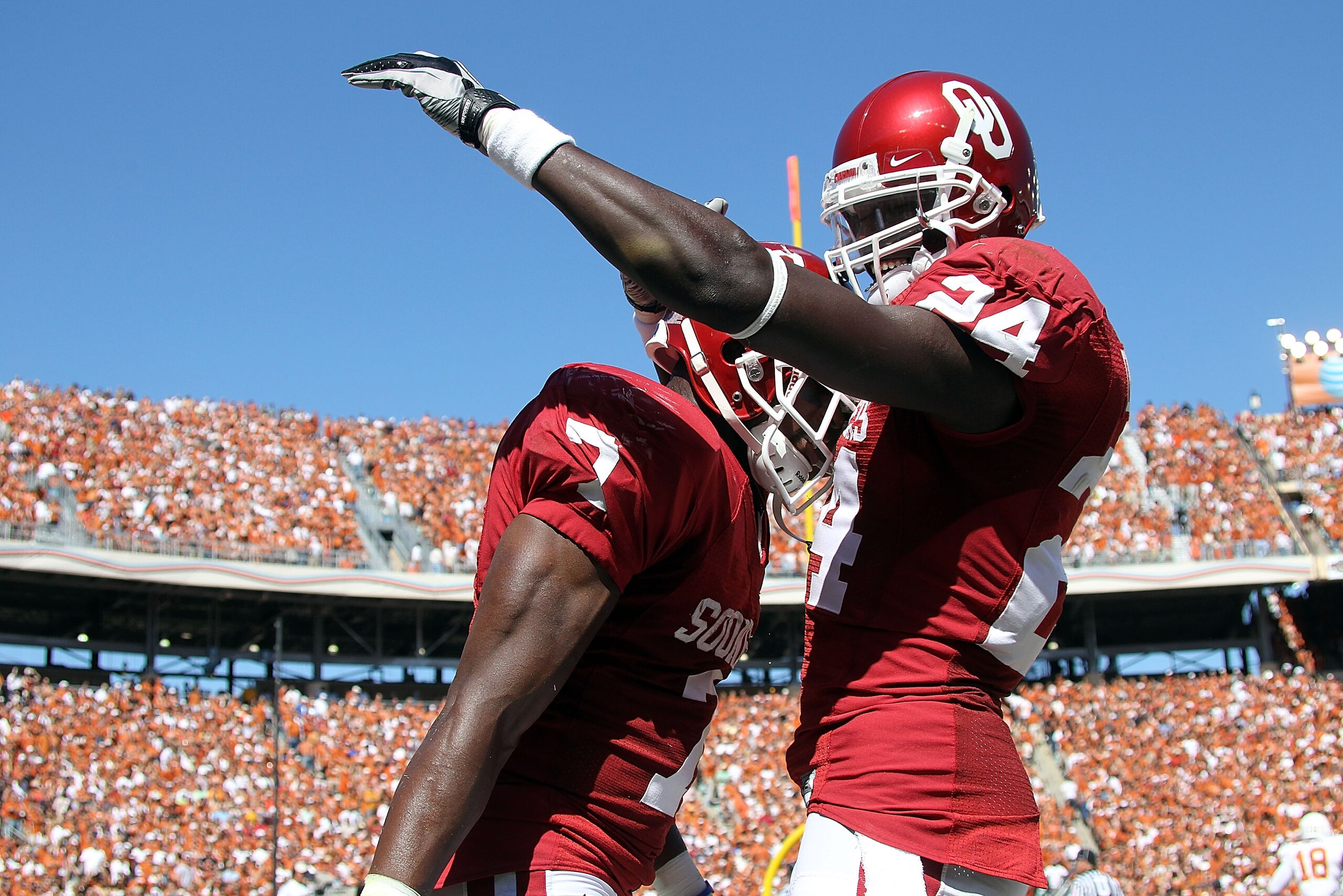 DALLAS - OCTOBER 02:  Running back Demarco Murray #7 of the Oklahoma Sooners celebrates a touchdown with Dejuan Miller #24 against the Texas Longhorns in the first quarter at the Cotton Bowl on October 2, 2010 in Dallas, Texas.  (Photo by Ronald Martinez/