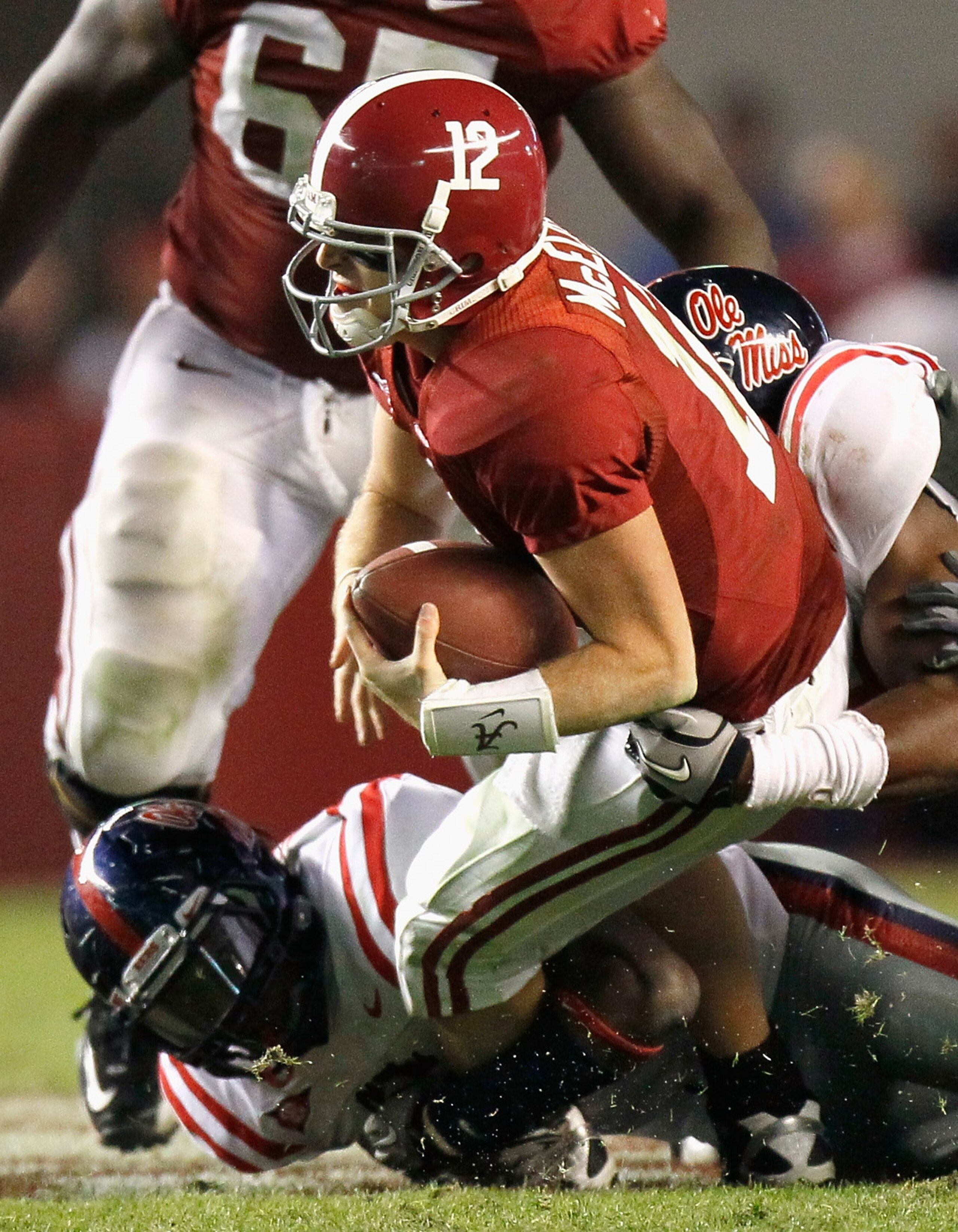 TUSCALOOSA, AL - OCTOBER 16: Quarterback Greg McElroy #12 of the Alabama Crimson Tide is sacked by Gerald Rivers #90 and D.T. Shackelford #42 of the Ole Miss Rebels at Bryant-Denny Stadium on October 16, 2010 in Tuscaloosa, Alabama. (Photo by Kevin C. C TUSCALOOSA, AL - OCTOBER 16: Quarterback Greg McElroy #12 of the Alabama Crimson Tide is sacked by Gerald Rivers #90 and D.T. Shackelford #42 of the Ole Miss Rebels at Bryant-Denny Stadium on October 16, 2010 in Tuscaloosa, Alabama. (Photo by Kevin C. C