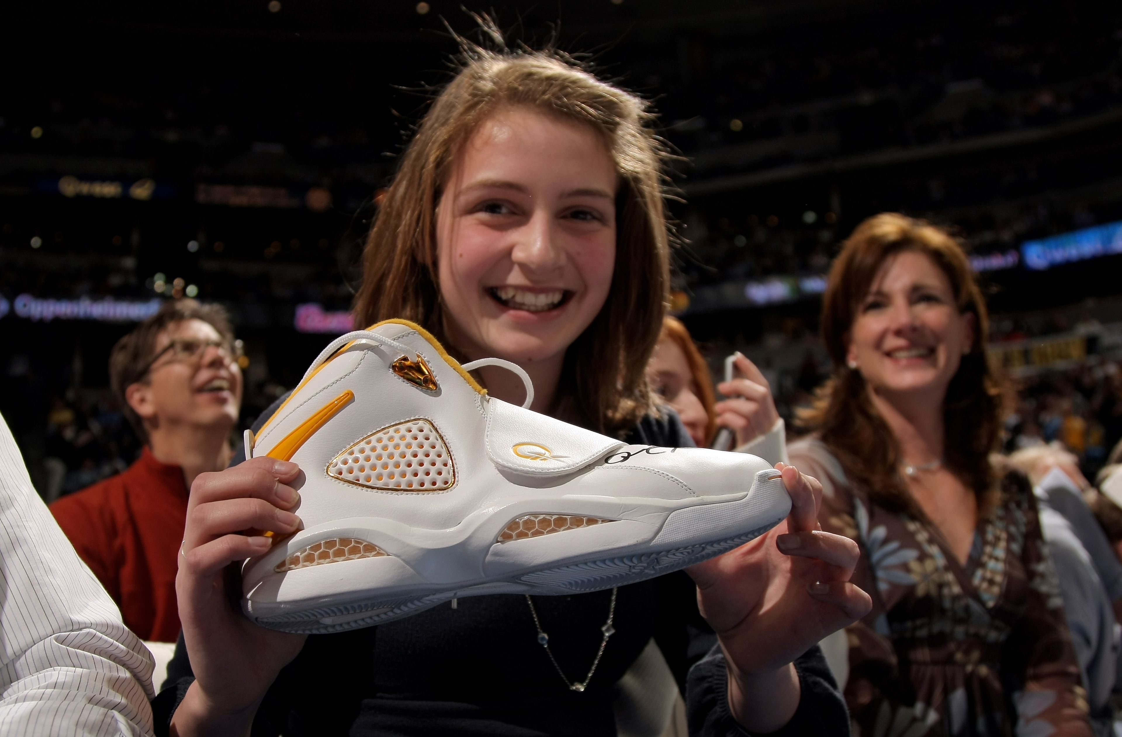 DENVER - MARCH 16:  Bridgette Anthony, 13, of Louisville, Colorado shows off the signed sneaker given to her by Allen Iverson #3 of the Denver Nuggets after leaving the game in the third quarter against the Seattle SuperSonics at the Pepsi Center March 16