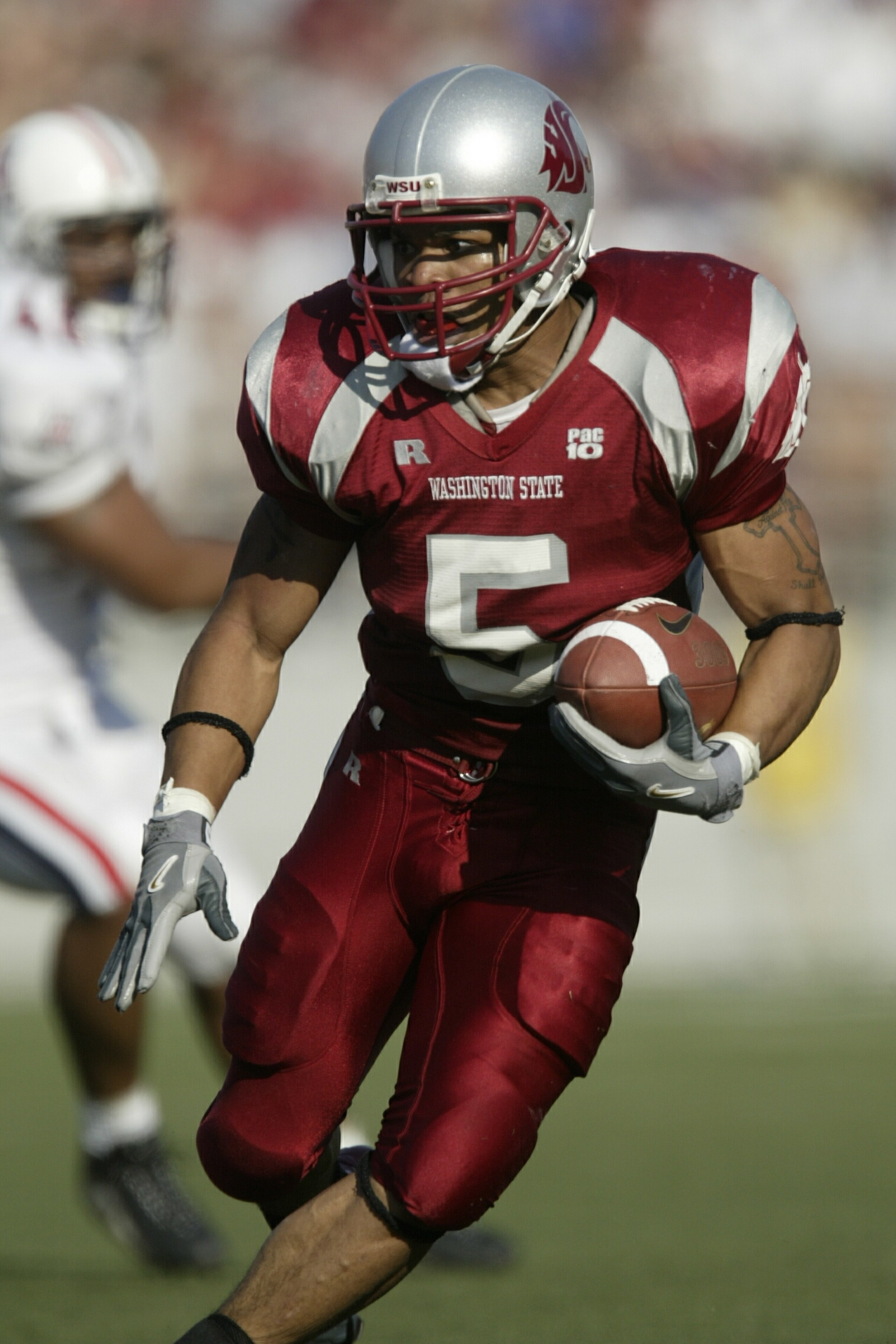 PULLMAN, WA - OCTOBER 03:  Runningback Jonathan Smith #5 of the Washington State Cougars rushes against the University of Arizona Wildcats on October3, 2003 at Martin Stadium in Pullman, Washington.  (Photo by Otto Greule Jr/Getty Images)
