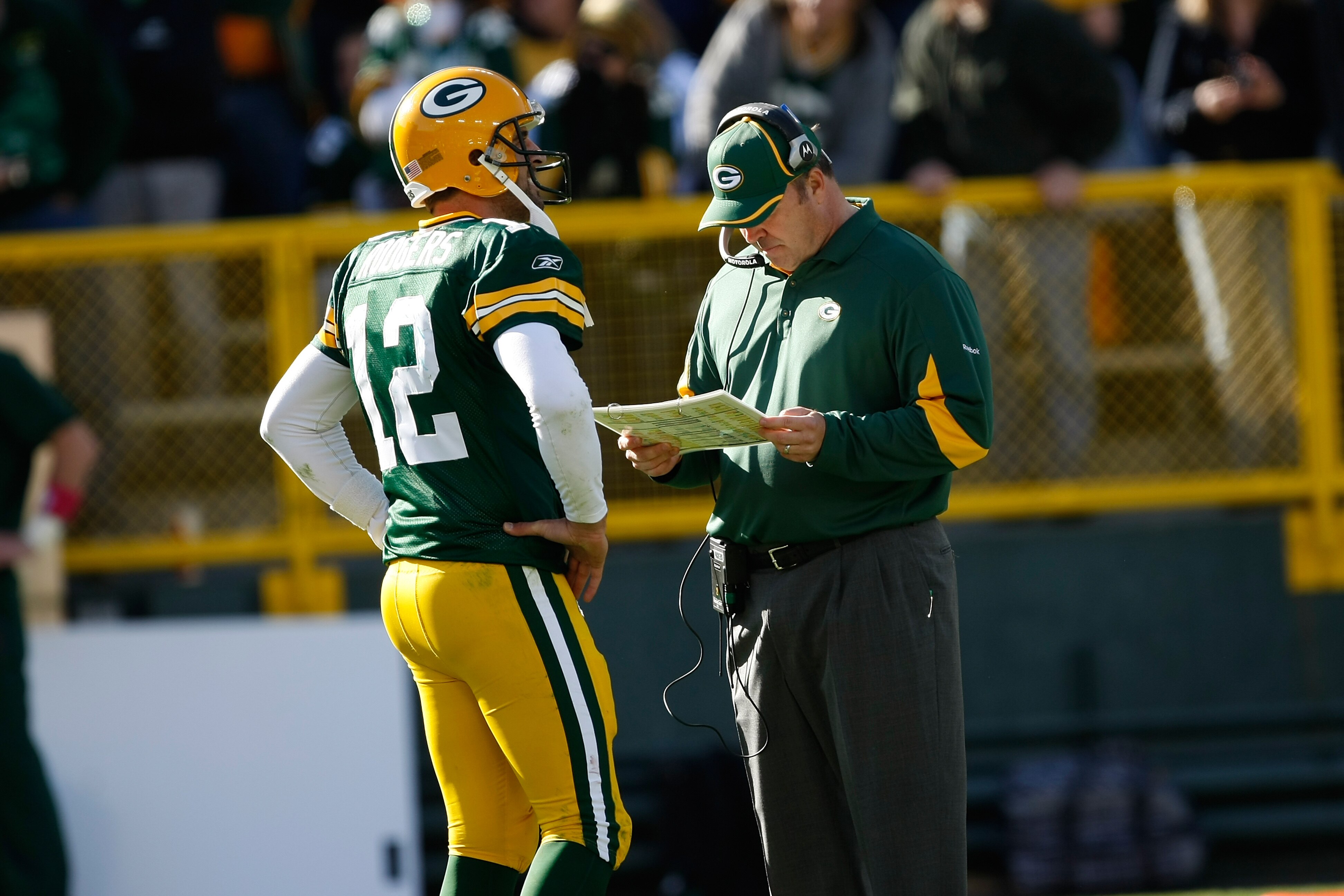 GREEN BAY, WI - OCTOBER 17: Aaron Rogers #12 of the Green Bay Packers talks with Mike McCarthy against the Miami Dolphins at Lambeau Field on October 17, 2010 in Green Bay, Wisconsin. The Dolphins defeated the Packers 23-20 in overtime. (Photo by Scott Bo