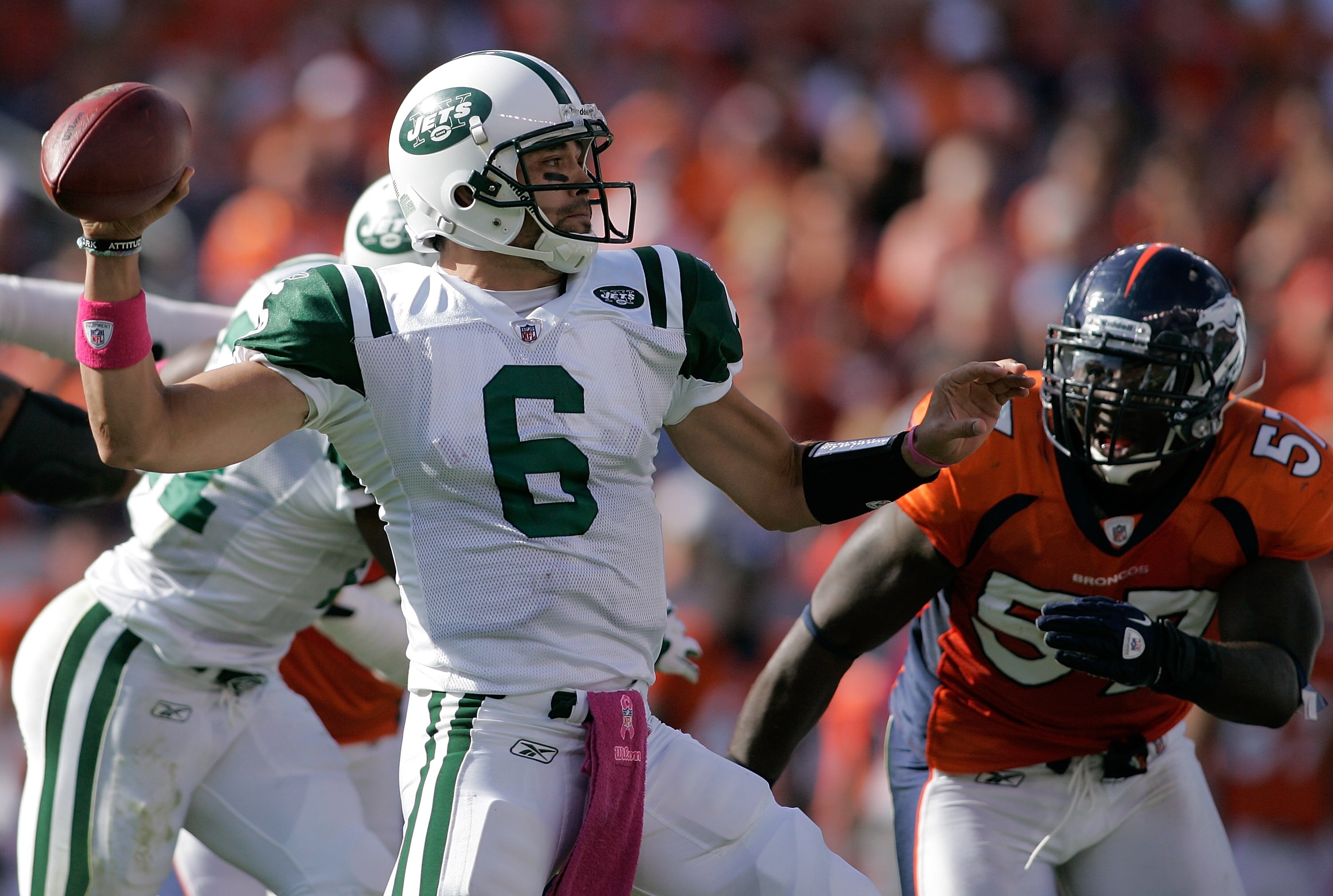 DENVER - OCTOBER 17:  Quarterback Mark Sanchez #6 the New York Jets makes a pass as linebacker Mario Haggan #57 of the Denver Broncos gives chase at INVESCO Field at Mile High on October 17, 2010 in Denver, Colorado.  (Photo by Justin Edmonds/Getty Images