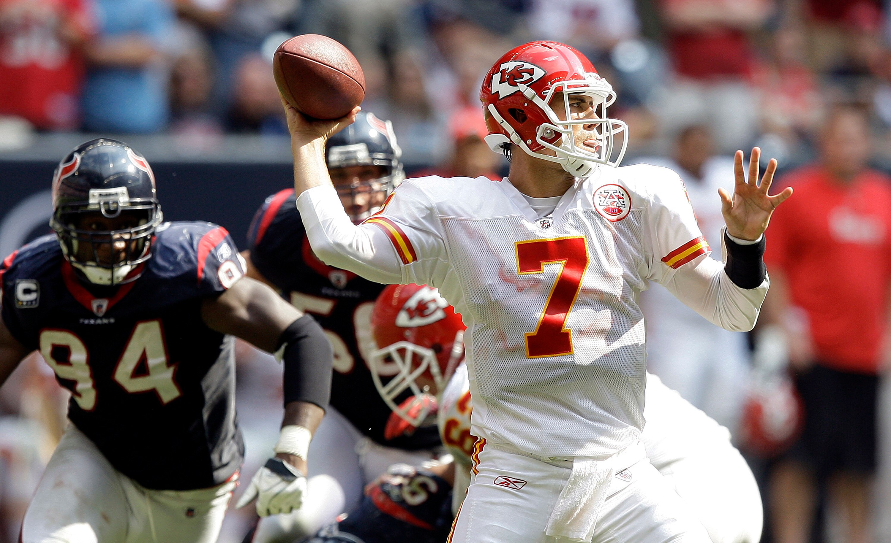 HOUSTON - OCTOBER 17:  Quarterback Matt Cassel #7 of the Kansas City Chiefs throws down field as Antonio Smith #94 of the Houston Texans looks to apply pressure> at Reliant Stadium on October 17, 2010 in Houston, Texas.  (Photo by Bob Levey/Getty Images)