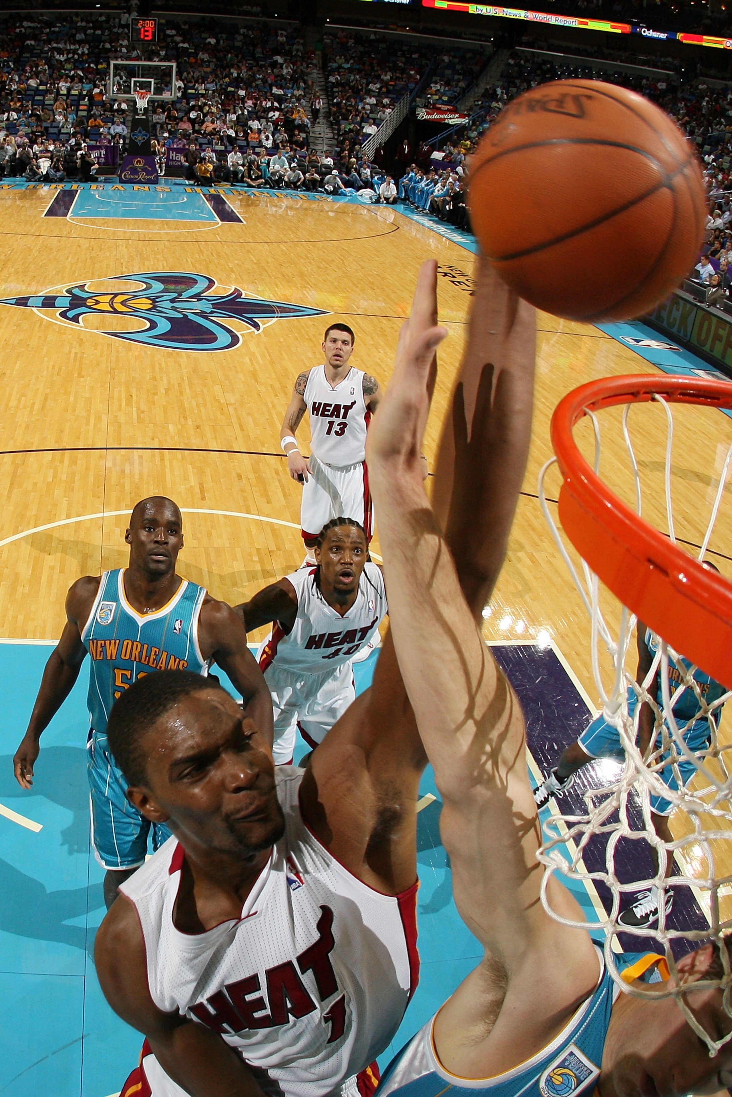 NEW ORLEANS - OCTOBER 13: Chris Bosh #1 of the Miami Heat dunks the ball over Jason Smith #14 of the New Orleans Hornets at the New Orleans Arena on October 13, 2010 in New Orleans, Louisiana. The Hornets defeated the Heat 90-76. NOTE TO USER: User ex NEW ORLEANS - OCTOBER 13: Chris Bosh #1 of the Miami Heat dunks the ball over Jason Smith #14 of the New Orleans Hornets at the New Orleans Arena on October 13, 2010 in New Orleans, Louisiana. The Hornets defeated the Heat 90-76. NOTE TO USER: User ex