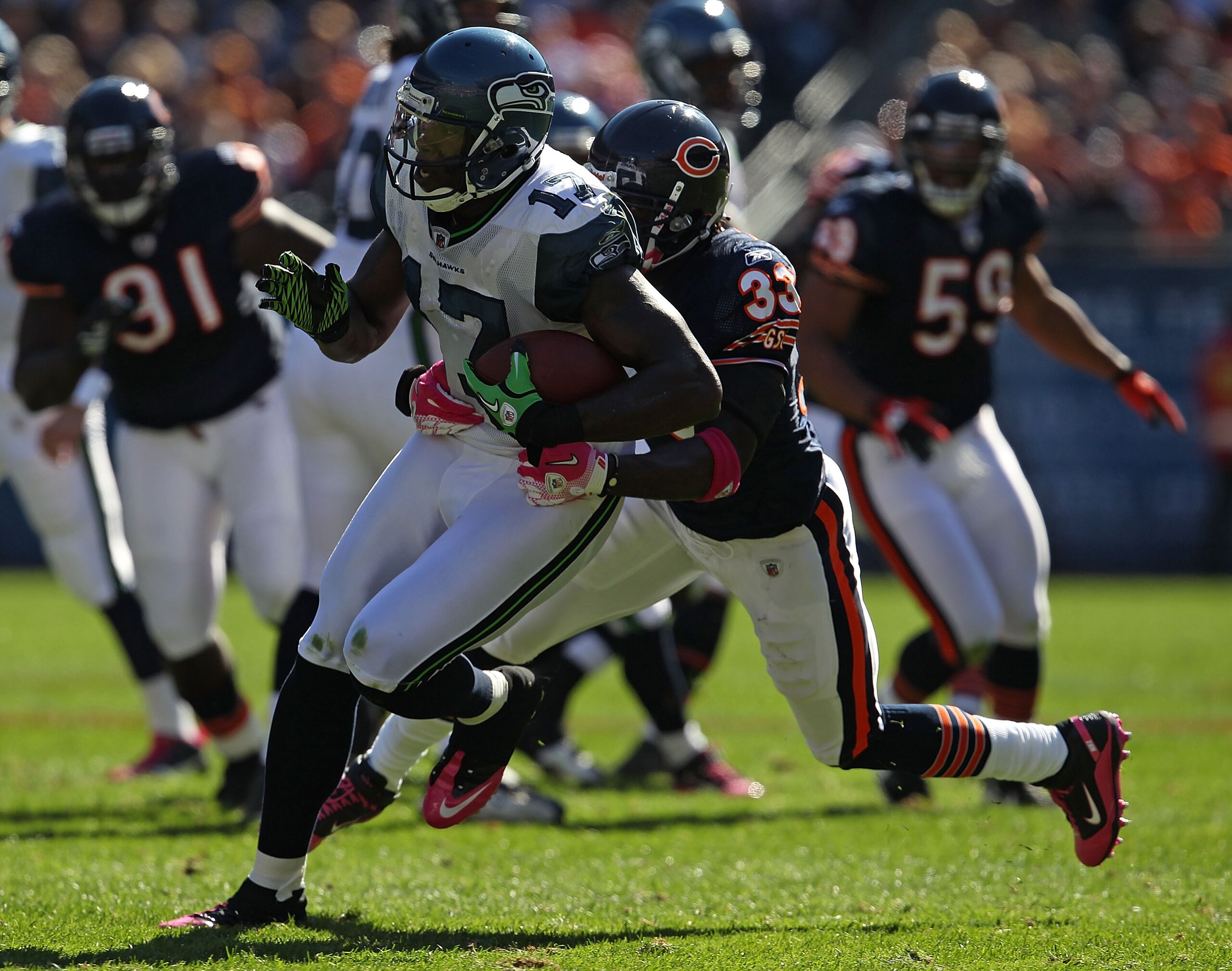 CHICAGO - OCTOBER 17: Mike Williams #17 of the Seattle Seahawks runs for a first down while being grabbed by Charles Tillman #33 of the Chicago Bears at Soldier Field on October 17, 2010 in Chicago, Illinois. (Photo by Jonathan Daniel/Getty Images)
