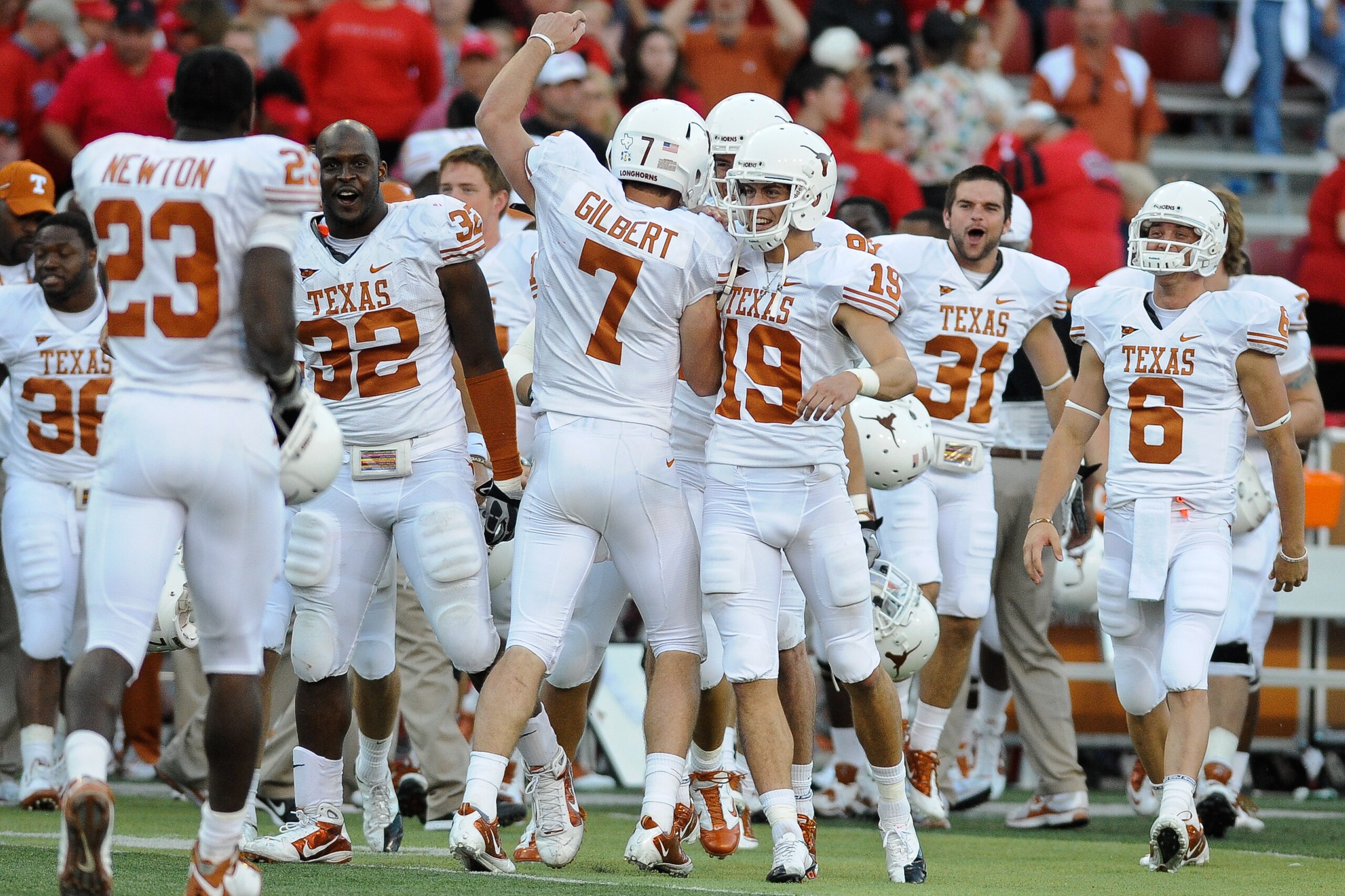 LINCOLN, NE - OCTOBER 16: Quarterback Garrett Gilbert #7 of the Texas Longhorns runs toward his teammates ofter the final of their game against the Nebraska Cornhuskers at Memorial Stadium on October 16, 2010 in Lincoln, Nebraska. Texas Defeated Nebraska LINCOLN, NE - OCTOBER 16: Quarterback Garrett Gilbert #7 of the Texas Longhorns runs toward his teammates ofter the final of their game against the Nebraska Cornhuskers at Memorial Stadium on October 16, 2010 in Lincoln, Nebraska. Texas Defeated Nebraska