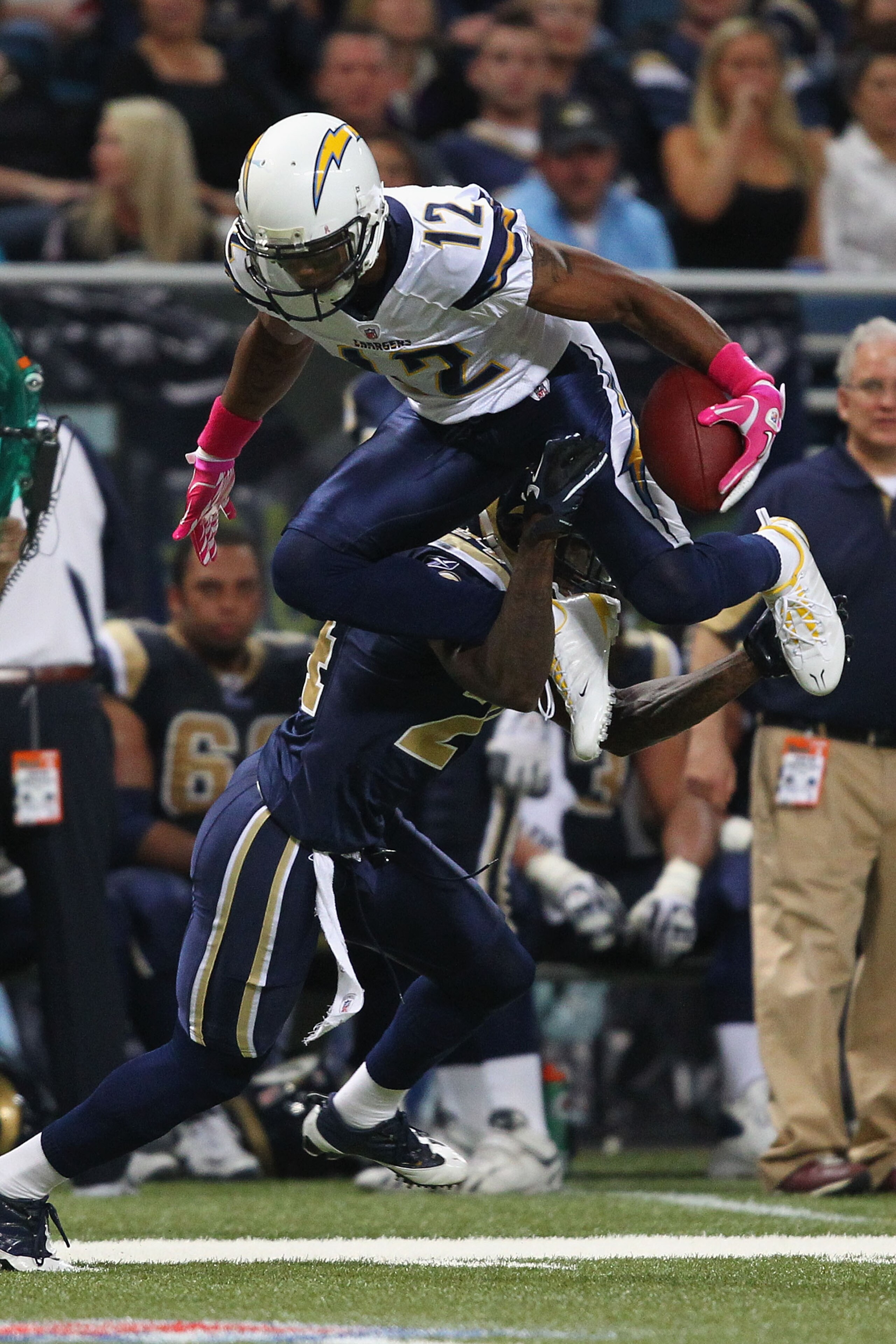 ST. LOUIS - OCTOBER 17: Patrick Crayton #12 of the San Diego Chargers leaps over Ronald Bartell #24 of the St. Louis Rams at the Edward Jones Dome on October 17, 2010 in St. Louis, Missouri.  The Rams beat the Chargers 20-17.  (Photo by Dilip Vishwanat/Ge