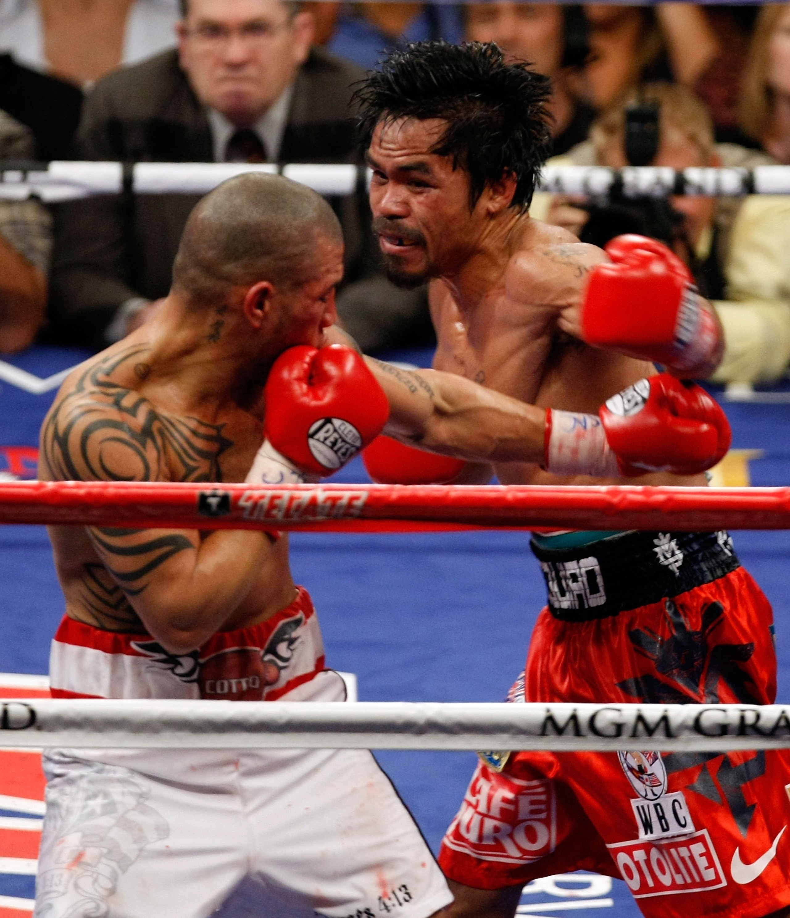 LAS VEGAS - NOVEMBER 14:  (R-L) Manny Pacquiao throws a left to the head of Miguel Cotto during their WBO welterweight title fight at the MGM Grand Garden Arena on November 14, 2009 in Las Vegas, Nevada. Pacquiao defeated Cotto by 12th round TKO.  (Photo