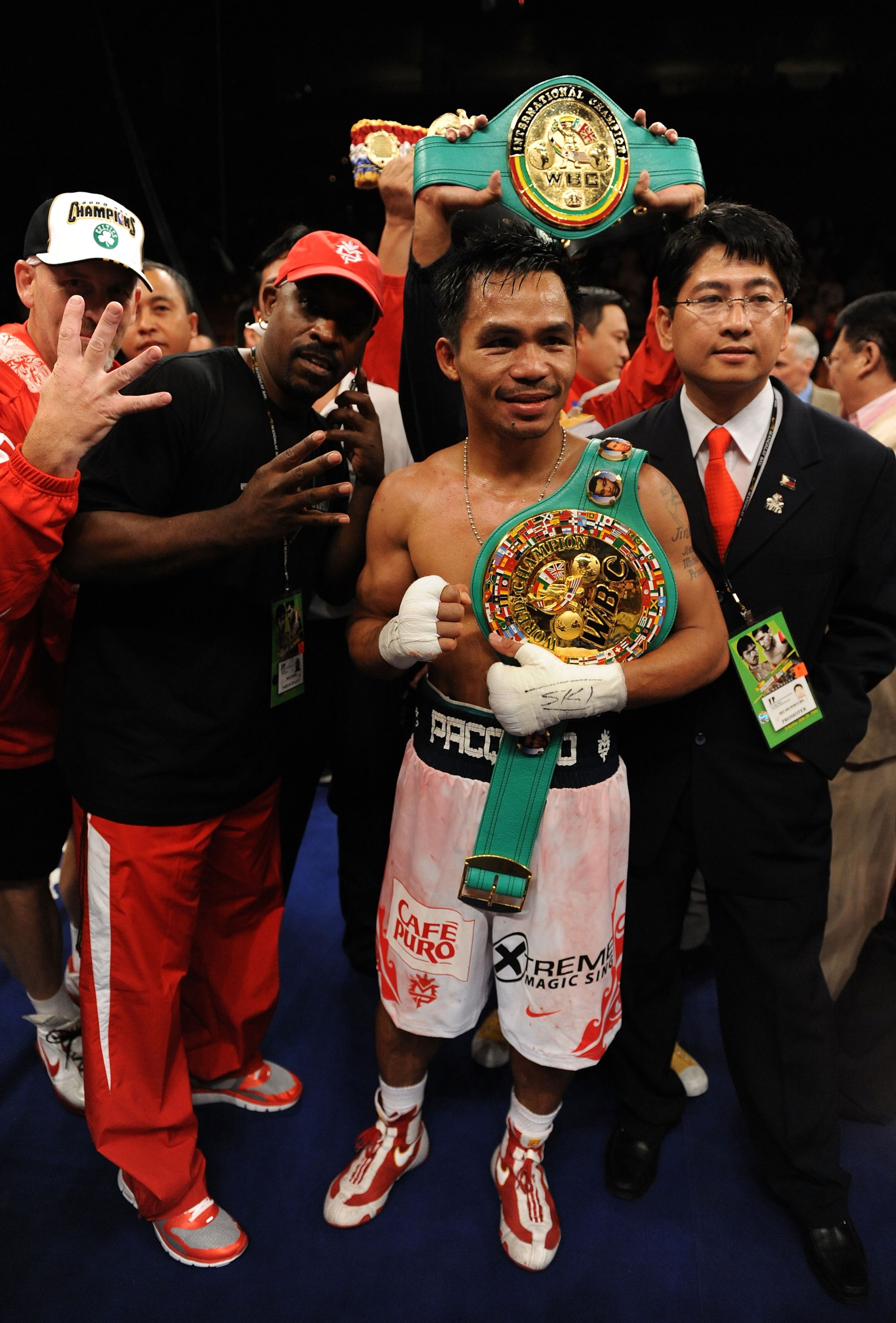 LAS VEGAS - JUNE 28:  Manny Pacquiao of the Phillipines celebrates his four belts after he knocks out David Diaz during the ninth round of the WBC Lightweight Championship at the Mandalay Bay Events Center on June 28, 2008 in Las Vegas, Nevada.  (Photo by