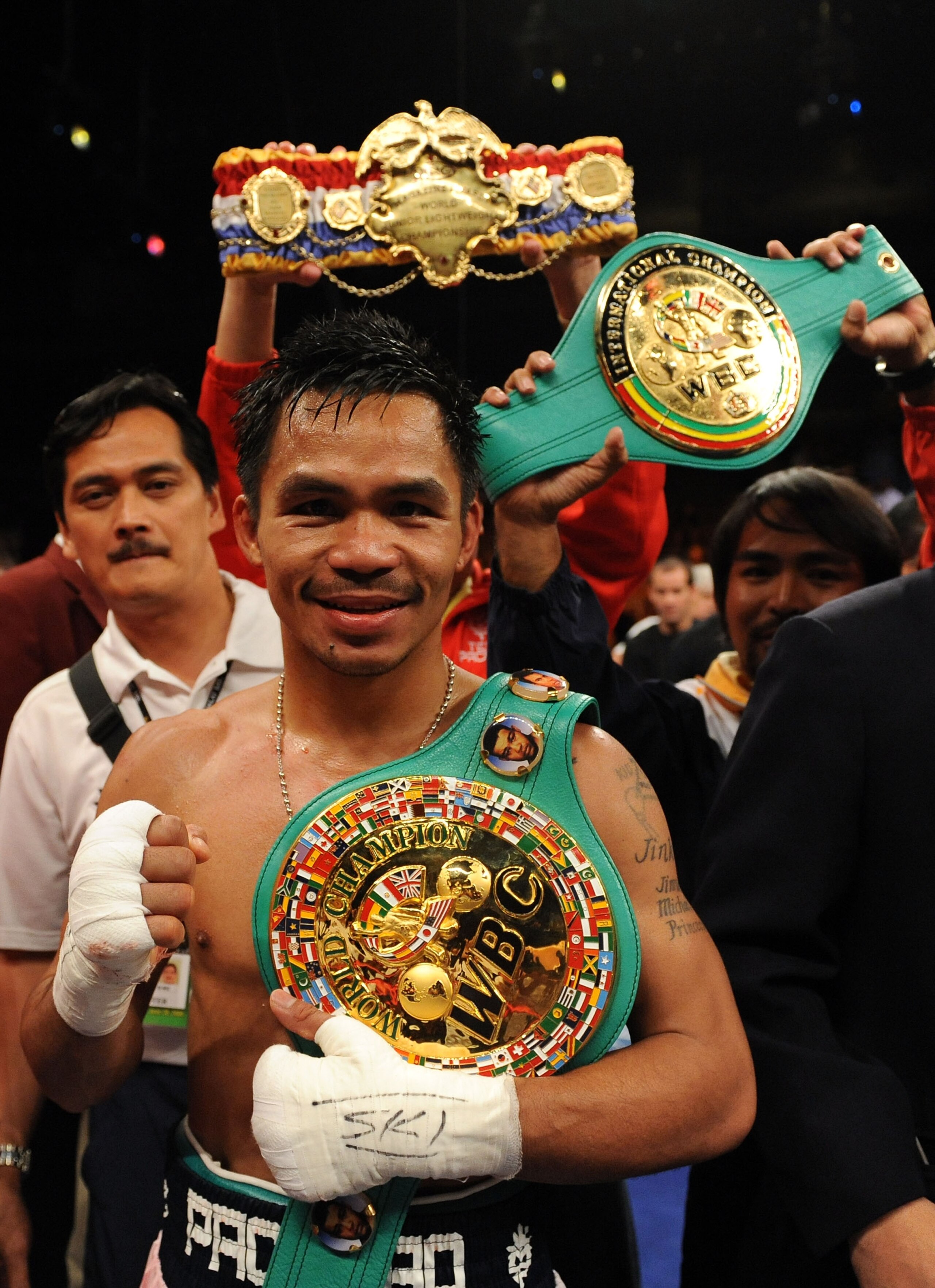 LAS VEGAS - JUNE 28:  Manny Pacquiao of the Philippines poses with his belts after he knocks out David Diaz during the ninth round of the WBC Lightweight Championship at the Mandalay Bay Events Center on June 28, 2008 in Las Vegas, Nevada.  (Photo by Harr