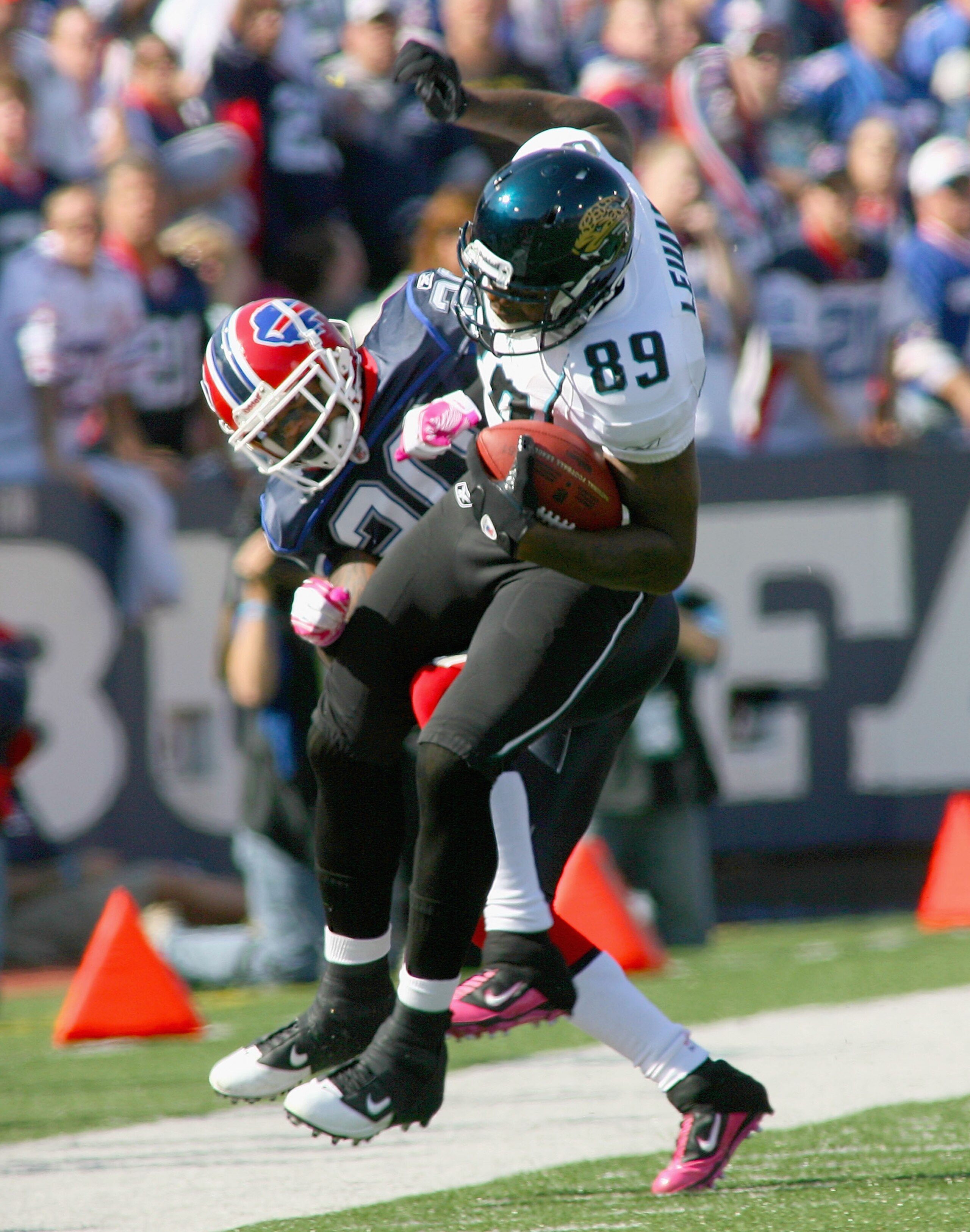 ORCHARD PARK, NY - OCTOBER 10: Marcedes Lewis #89 of the Jacksonville Jaguars is pulled out of bounds by Donte Whitner #20 of the Buffalo Bills at Ralph Wilson Stadium on October 10, 2010 in Orchard Park, New York. Jacksonville won 36-26. (Photo by Rick S