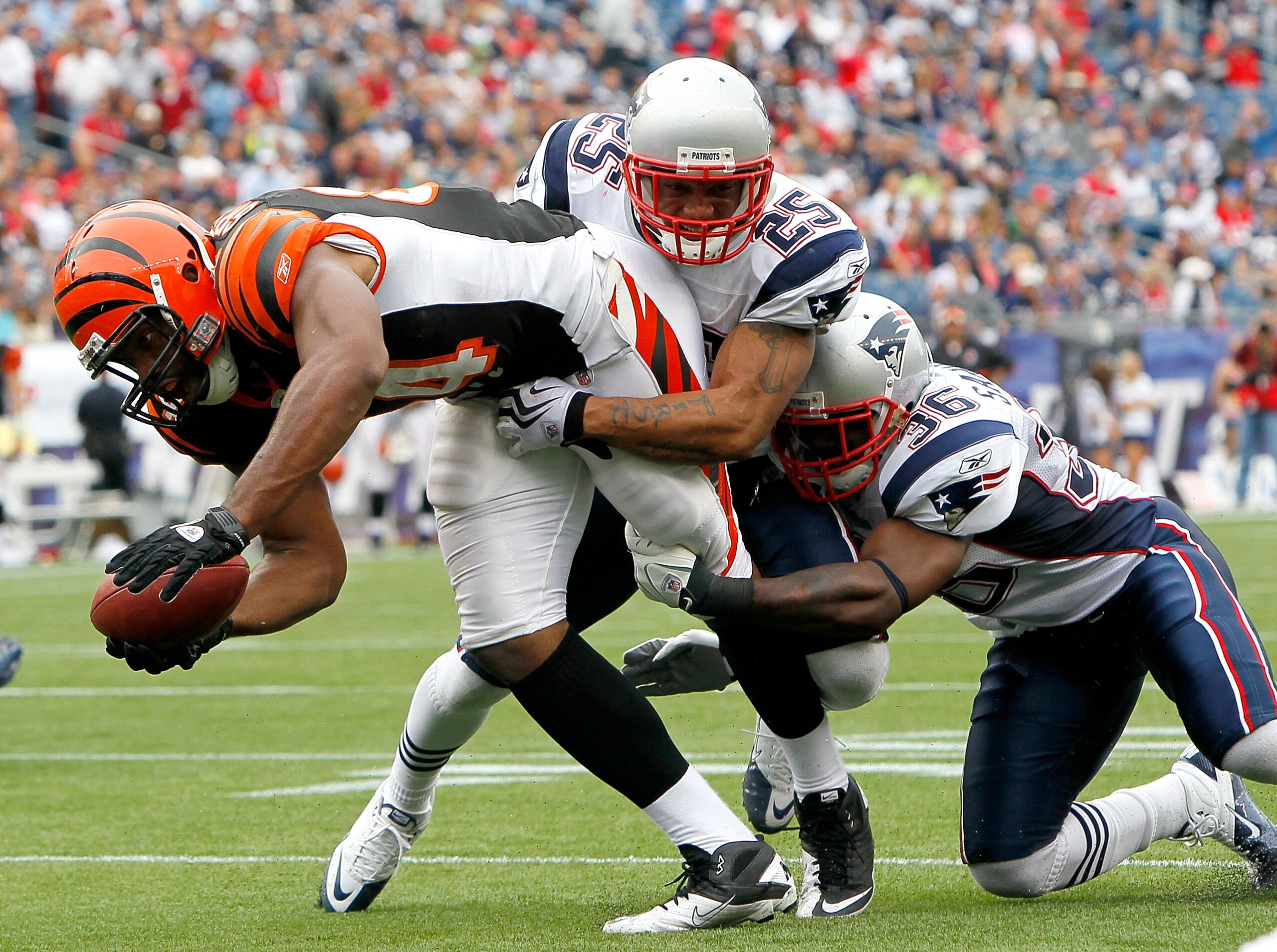 FOXBORO, MA - SEPTEMBER 12:  Jonathan Wilhite #24 and James Sanders #36 of the New England Patriots stop Jermaine Gresham #84 of the Cincinnati Bengals at the goal line during the NFL season opener at Gillette Stadium on September 12, 2010 in Foxboro, Mas