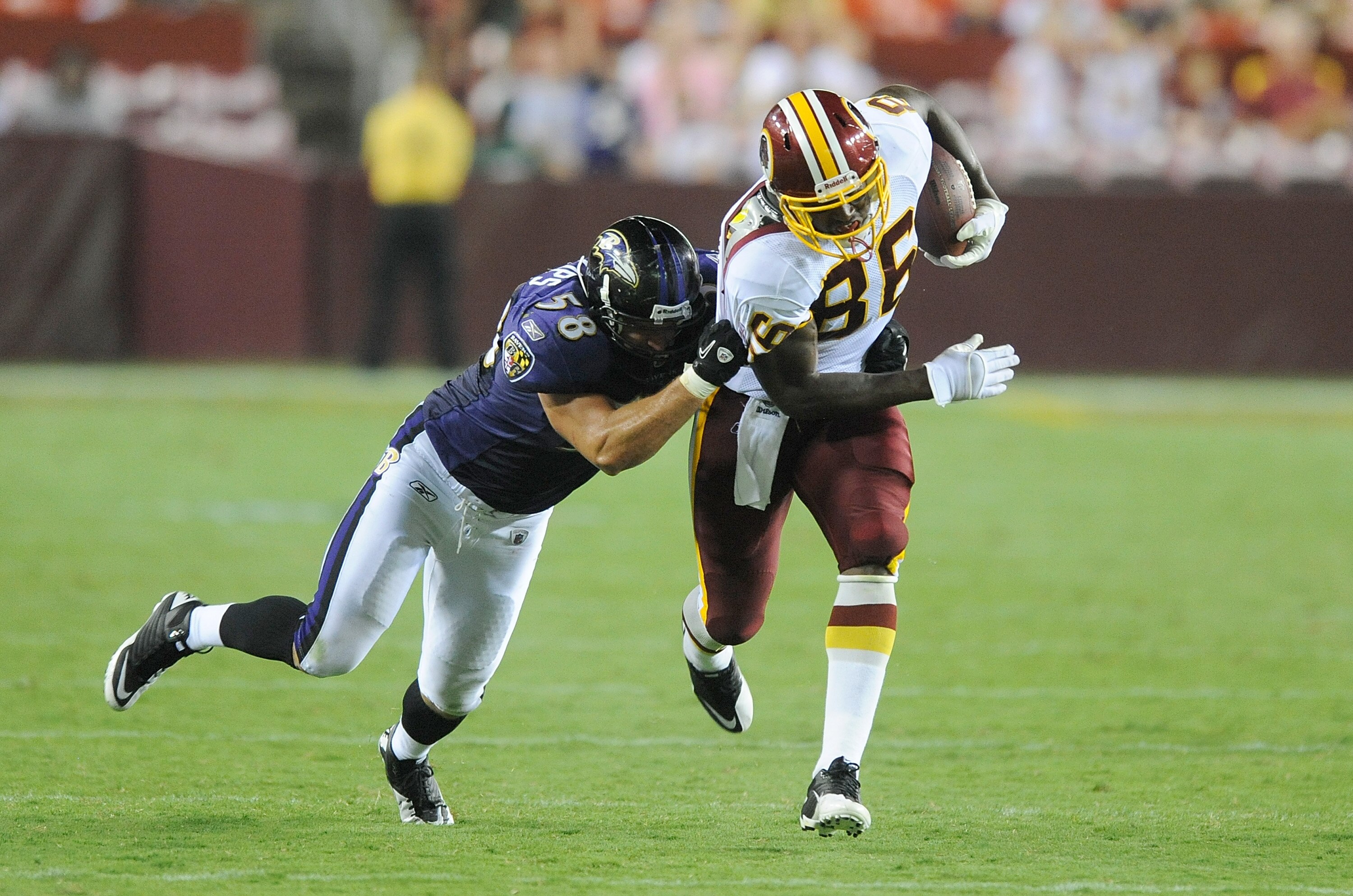 LANDOVER, MD - AUGUST 21:  Fred Davis #86 of the Washington Redskins is tackled during the preseason game by Jason Phillips #58 of the Baltimore Ravens at FedExField on August 21, 2010 in Landover, Maryland.  (Photo by Greg Fiume/Getty Images)