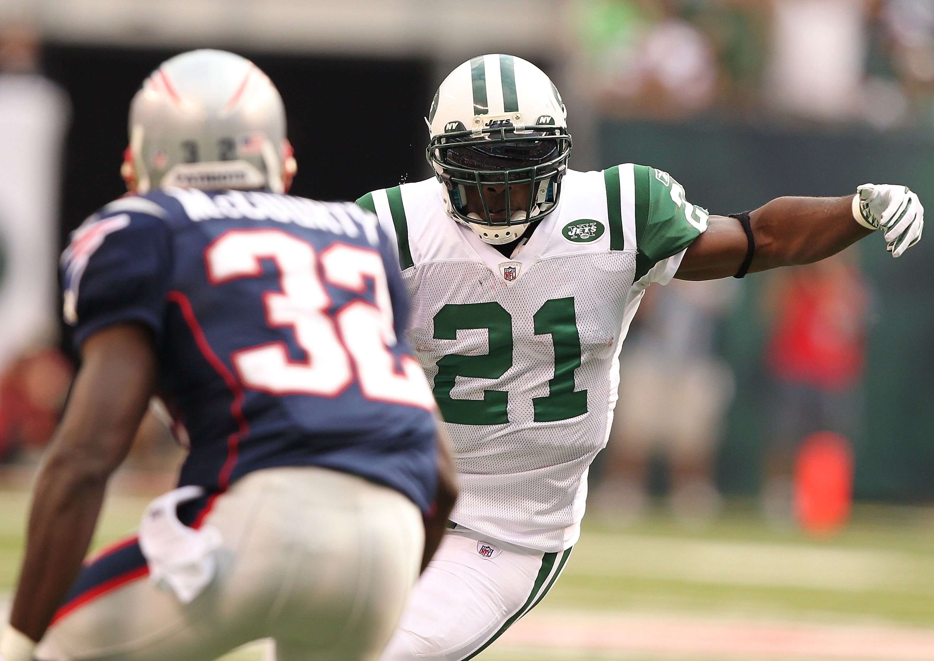EAST RUTHERFORD, NJ - SEPTEMBER 19:  LaDainian Tomlinson #21  of the New York Jets is is met by Devin McCourty #32 of the New England Patriots during their  game on September 19, 2010 at the New Meadowlands Stadium  in East Rutherford, New Jersey.  (Photo