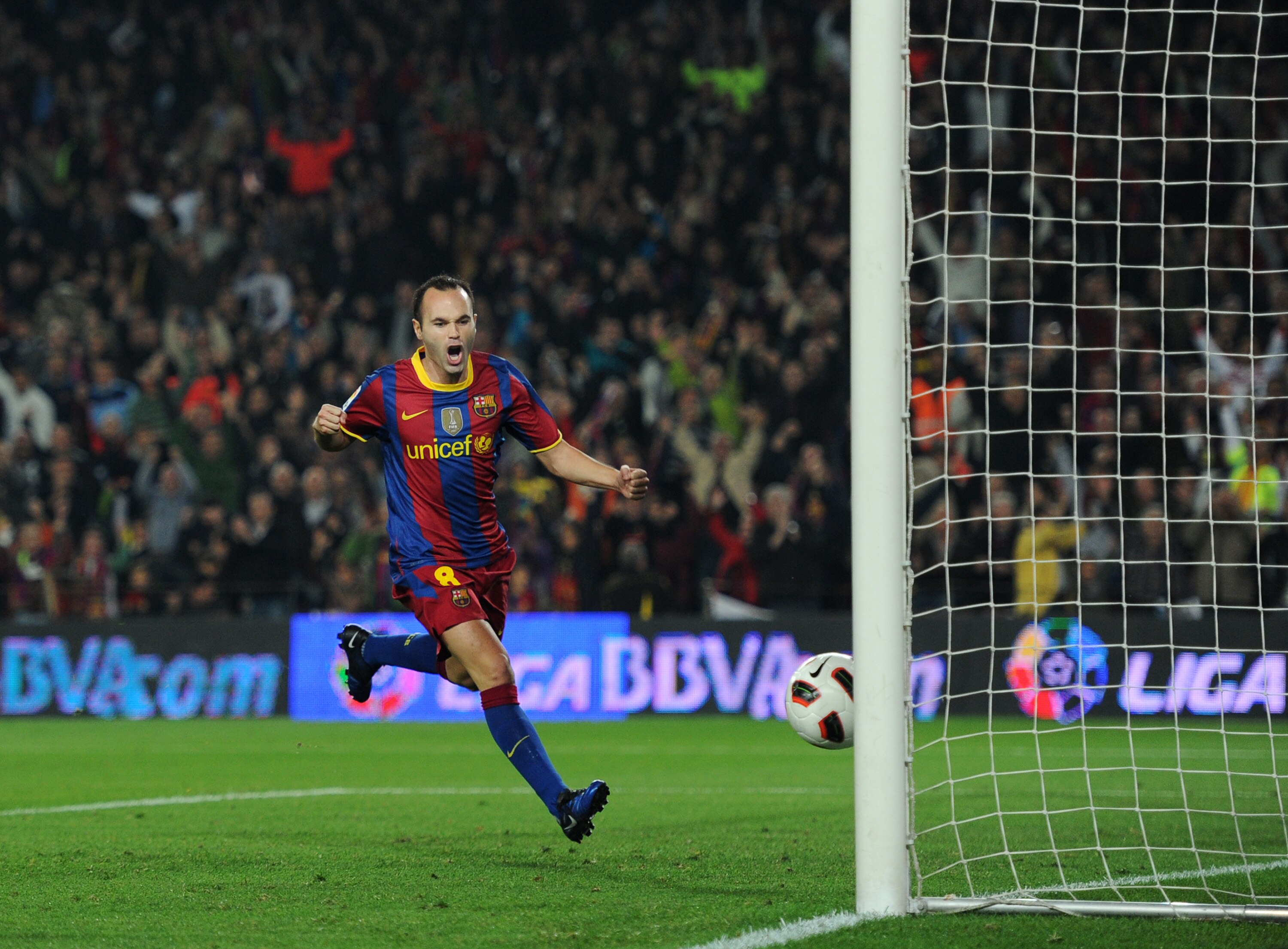 BARCELONA, SPAIN - OCTOBER 16:  Andres Iniesta (L) of Barcelona celebrates scoring his sides equalizing goal during the La Liga match between Barcelona and Valencia at the Camp Nou stadium on October 16, 2010 in Barcelona, Spain. Barcelona won the match 2