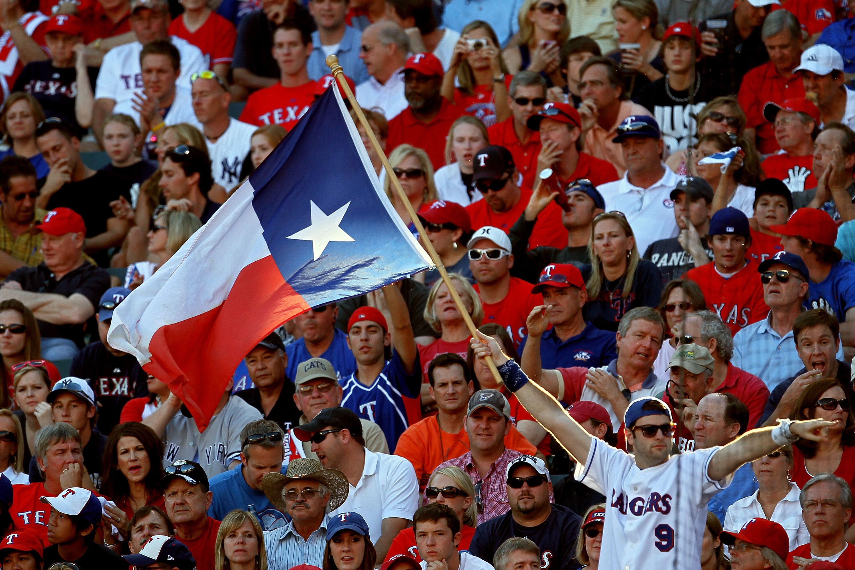 ARLINGTON, TX - OCTOBER 16:  A fan holds up the Texas state flag during Game Two of the ALCS during the 2010 MLB Playoffs at Rangers Ballpark in Arlington on October 16, 2010 in Arlington, Texas.  (Photo by Stephen Dunn/Getty Images)