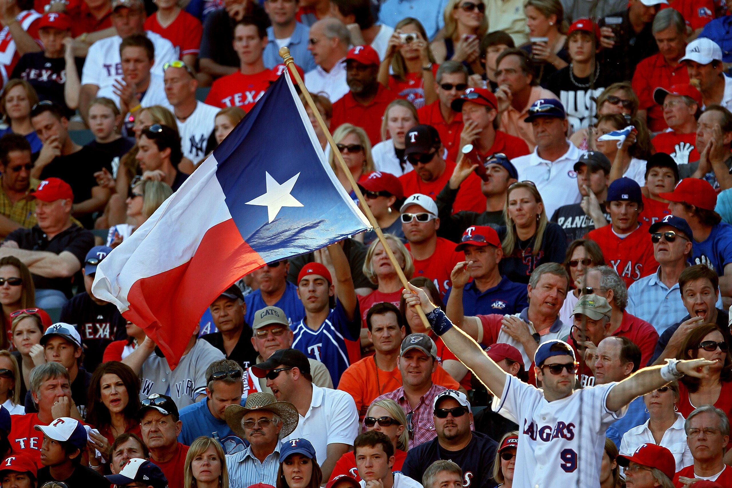 ARLINGTON, TX - OCTOBER 16: A fan holds up the Texas state flag during Game Two of the ALCS during the 2010 MLB Playoffs at Rangers Ballpark in Arlington on October 16, 2010 in Arlington, Texas. (Photo by Stephen Dunn/Getty Images) ARLINGTON, TX - OCTOBER 16: A fan holds up the Texas state flag during Game Two of the ALCS during the 2010 MLB Playoffs at Rangers Ballpark in Arlington on October 16, 2010 in Arlington, Texas. (Photo by Stephen Dunn/Getty Images)