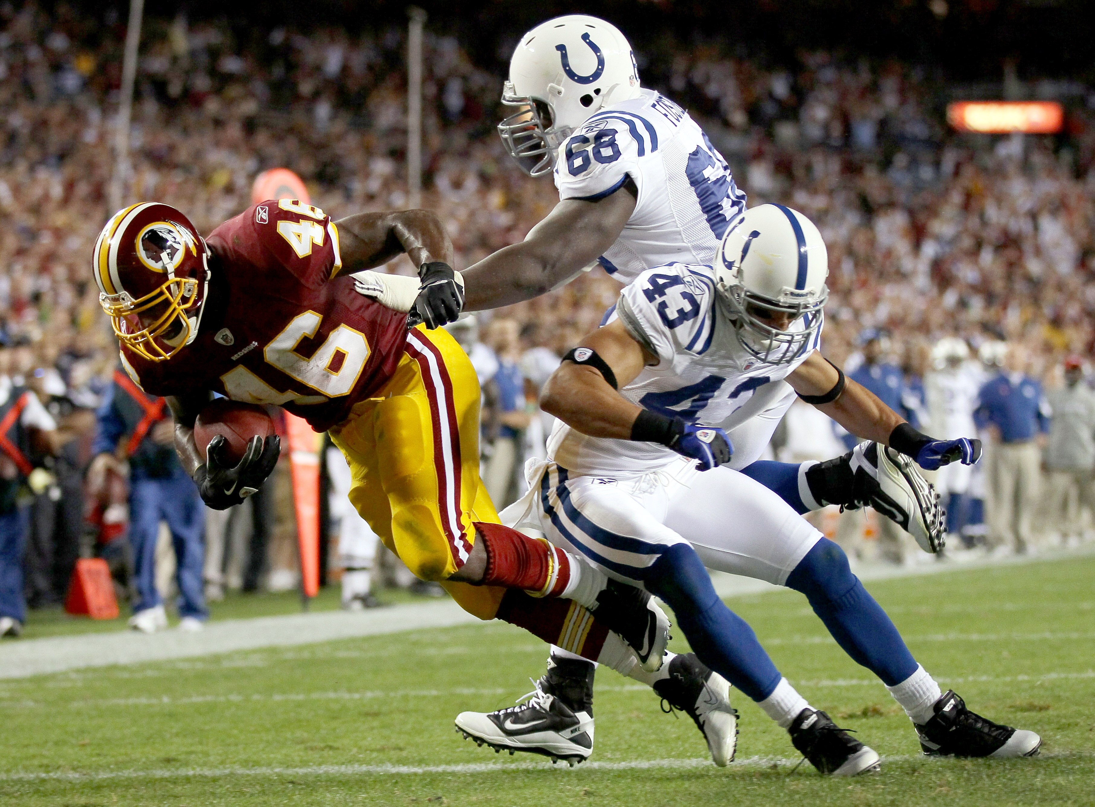 LANDOVER, MD - OCTOBER 17: Running back Ryan Torain #46 of the Washington Redskins scores a touchdown against Eric Foster #68 and Aaron Francisco #23 of the Indianapolis Colts at FedExField on October 17, 2010 in Landover, Maryland.  (Photo by Win McNamee