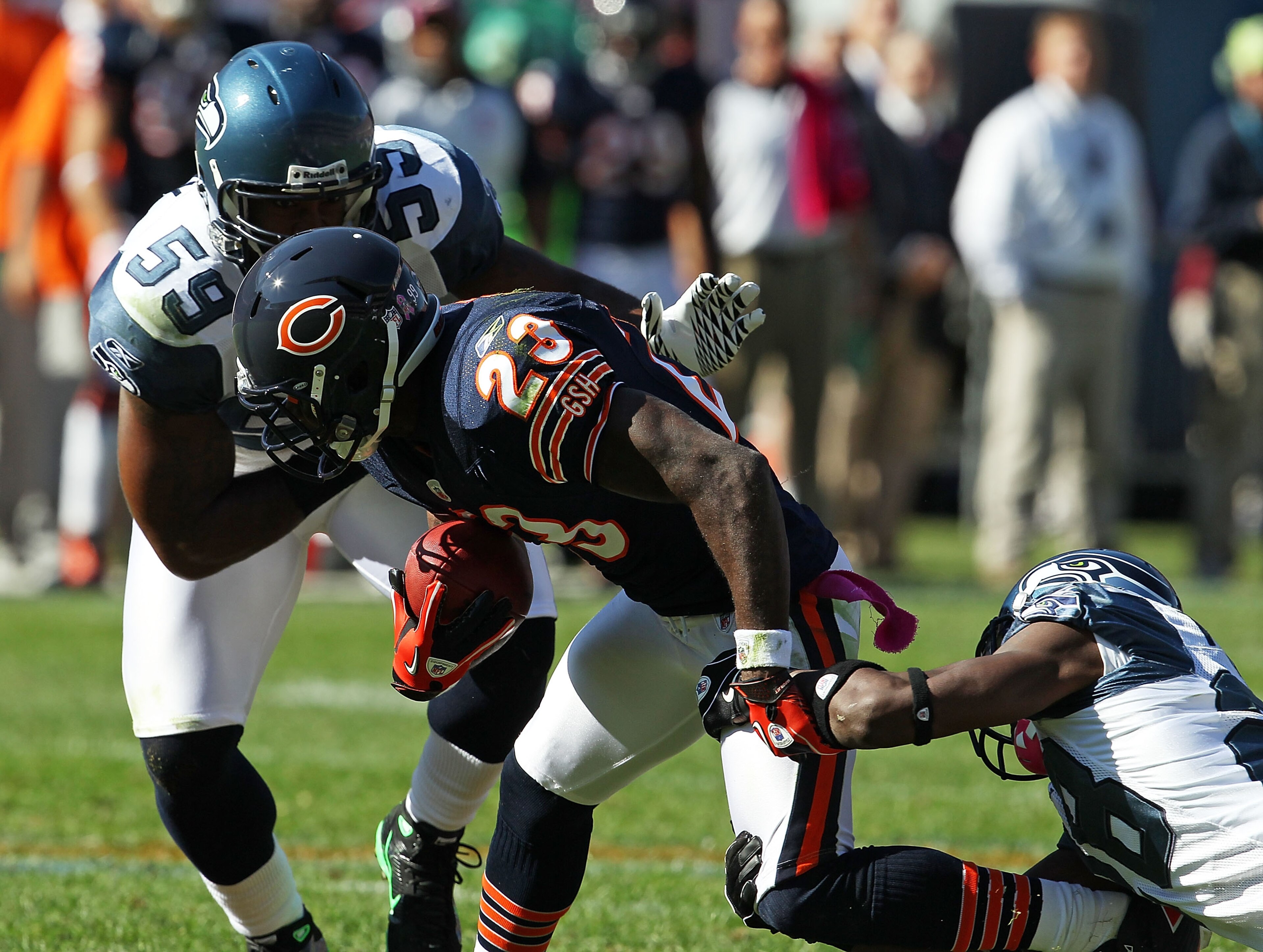 CHICAGO - OCTOBER 17: Devin Hester #23 of the Chicago Bears is tackled by Walter Thurmond #28 and Aaron Curry #59 of the Seattle Seahawks at Soldier Field on October 17, 2010 in Chicago, Illinois. The Seahawks defeated the Bears 23-20. (Photo by Jonathan 
