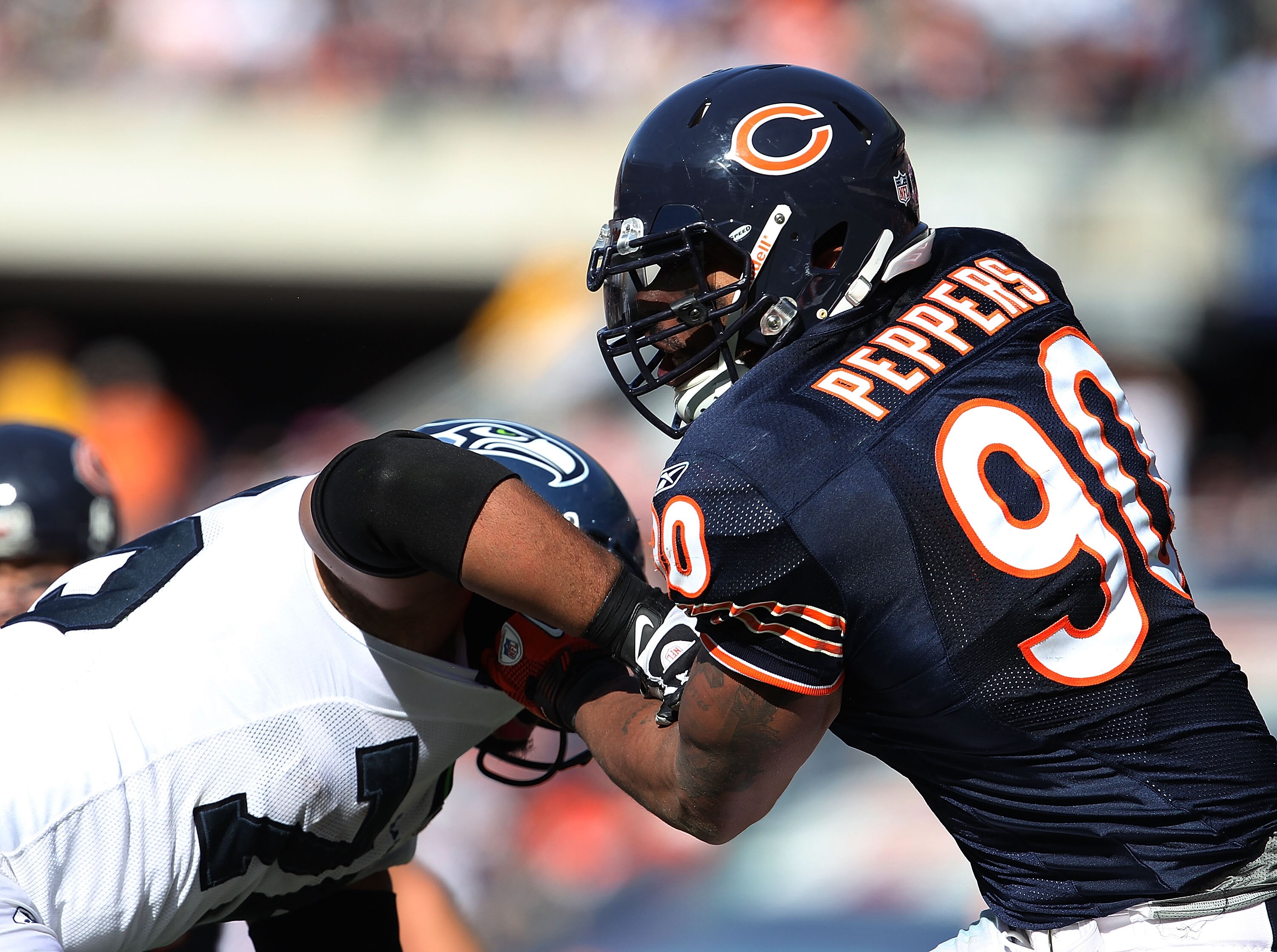 CHICAGO - OCTOBER 17: Julius Peppers #90 of the Chicago Bears rushes against Sean Locklear #75 of the Seattle Seahawks at Soldier Field on October 17, 2010 in Chicago, Illinois. The Seahawks defeated the Bears 23-20. (Photo by Jonathan Daniel/Getty Images
