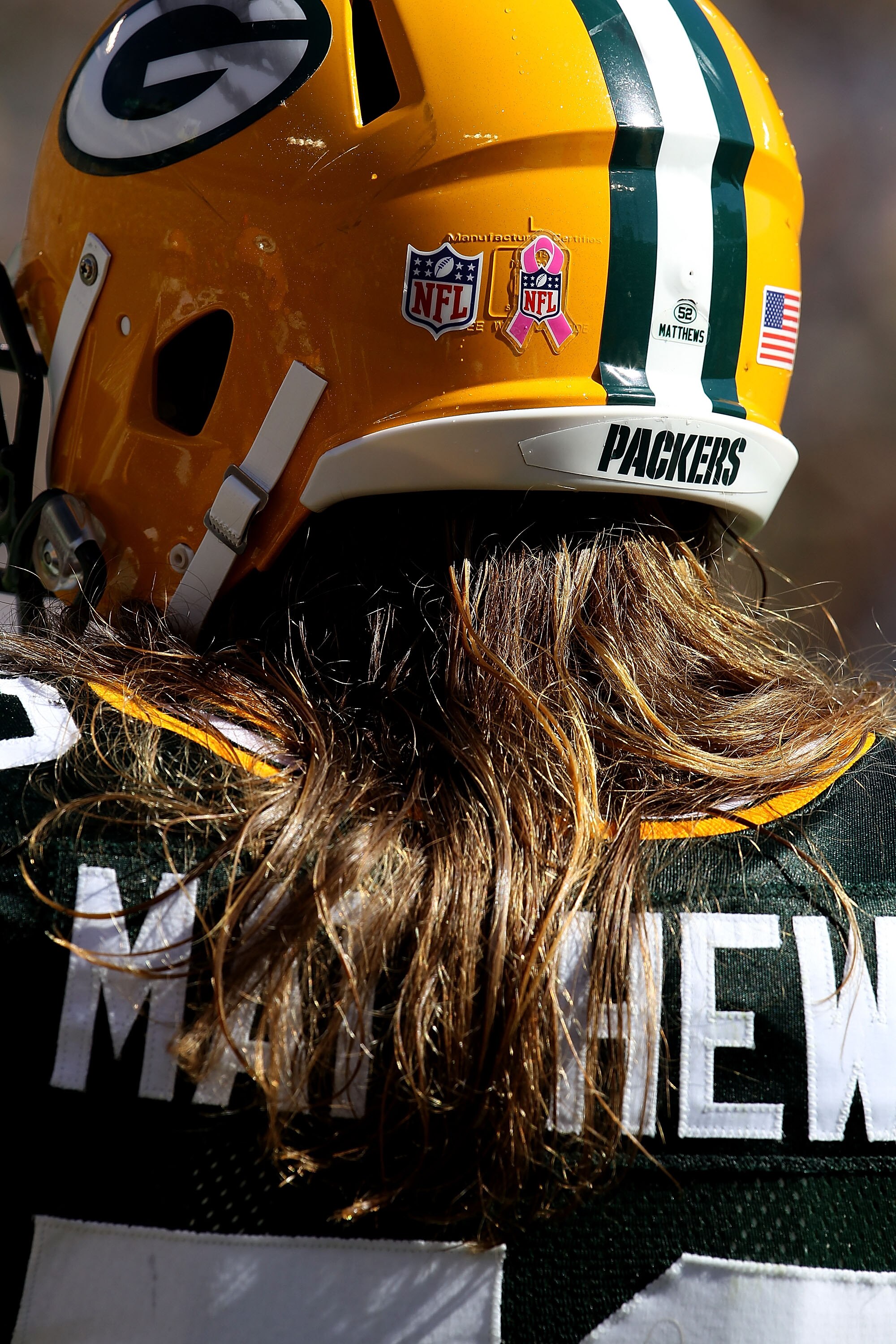 GREEN BAY, WI - OCTOBER 03: Clay Matthews #52 of the Green Bay Packers wears a sticker on the back of his helmut for breast cancer awarness during a game against the Detroit Lions at Lambeau Field on October 3, 2010 in Green Bay, Wisconsin. (Photo by Jona