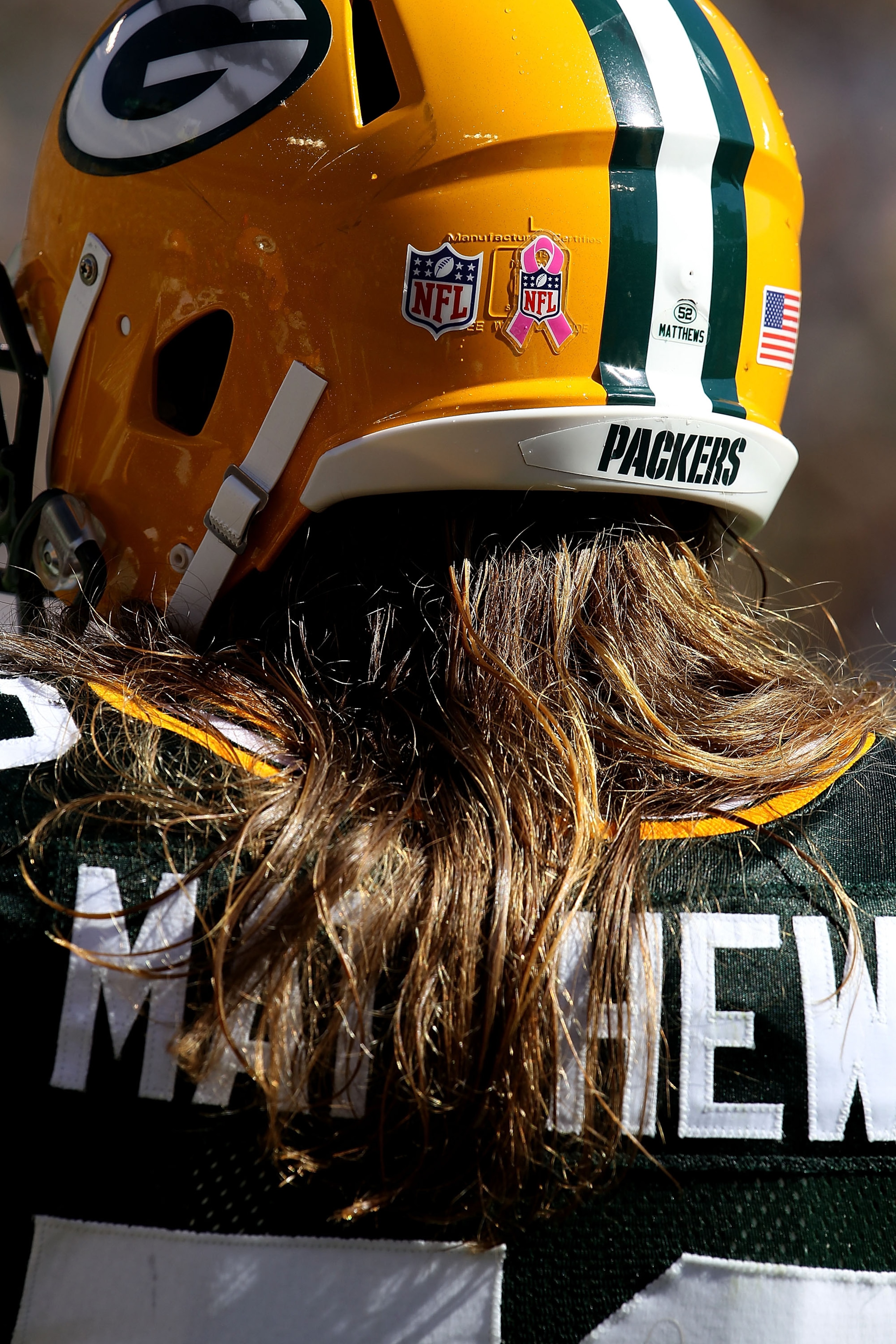 GREEN BAY, WI - OCTOBER 03: Clay Matthews #52 of the Green Bay Packers wears a sticker on the back of his helmut for breast cancer awarness during a game against the Detroit Lions at Lambeau Field on October 3, 2010 in Green Bay, Wisconsin. (Photo by Jona