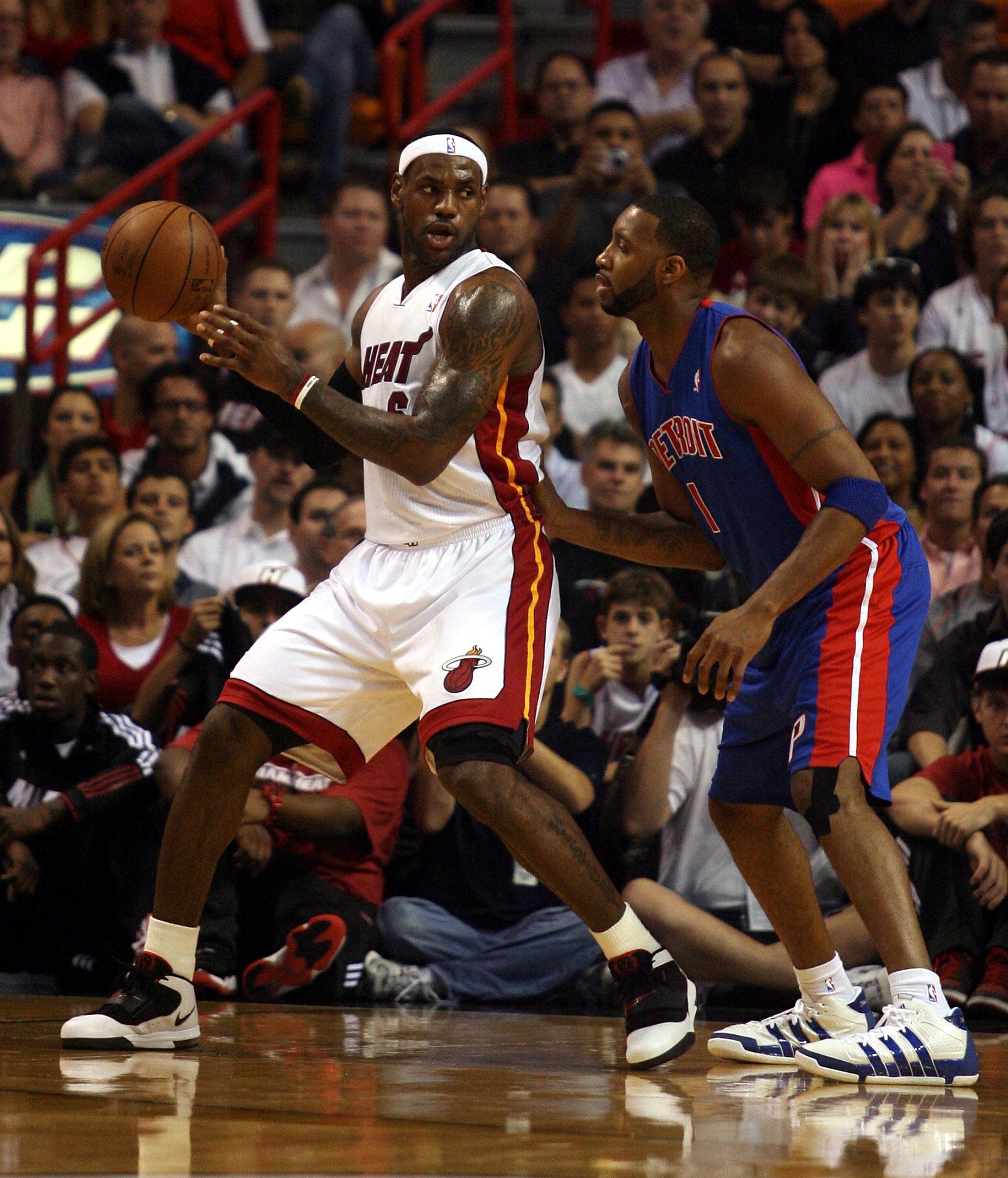 MIAMI - OCTOBER 05:  Forward LeBron James #6 of the Miami Heat takes on guard Tracy McGrady #1 of  the Detroit Pistons on October 5, 2010 in Miami, Florida.  NOTE TO USER: User expressly acknowledges and agrees that, by downloading and or using this photo