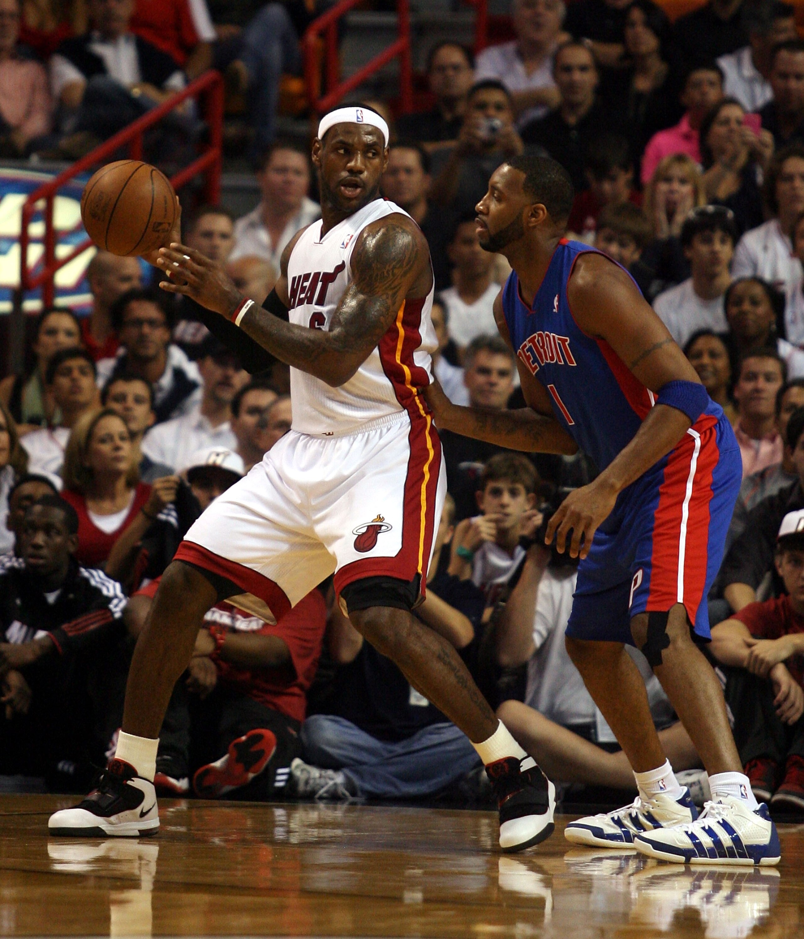 MIAMI - OCTOBER 05:  Forward LeBron James #6 of the Miami Heat takes on guard Tracy McGrady #1 of  the Detroit Pistons on October 5, 2010 in Miami, Florida.  NOTE TO USER: User expressly acknowledges and agrees that, by downloading and or using this photo