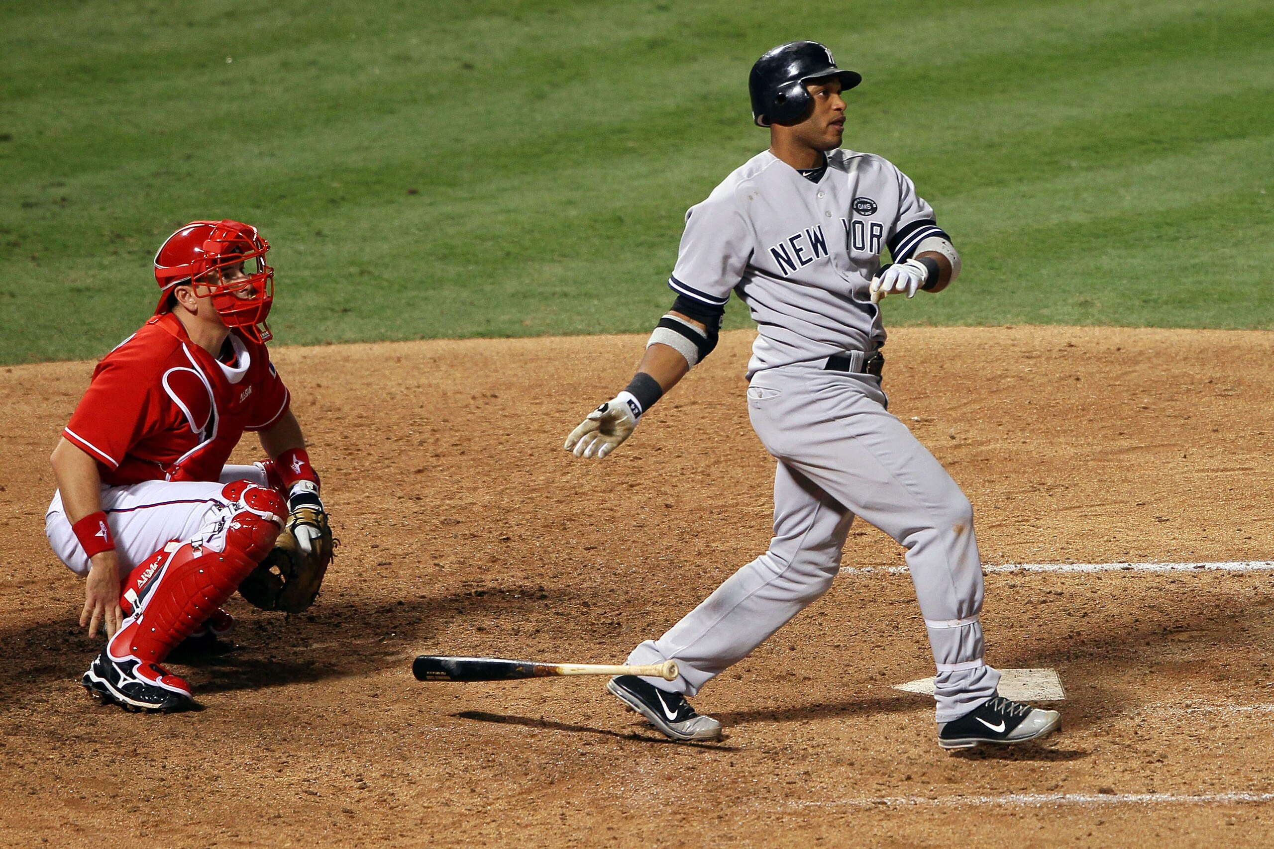 ARLINGTON, TX - OCTOBER 15: Robinson Cano #24 of the New York Yankees hits a solo home run in the seventh inning against the Texas Rangers in Game One of the ALCS during the 2010 MLB Playoffs at Rangers Ballpark in Arlington on October 15, 2010 in Arling ARLINGTON, TX - OCTOBER 15: Robinson Cano #24 of the New York Yankees hits a solo home run in the seventh inning against the Texas Rangers in Game One of the ALCS during the 2010 MLB Playoffs at Rangers Ballpark in Arlington on October 15, 2010 in Arling