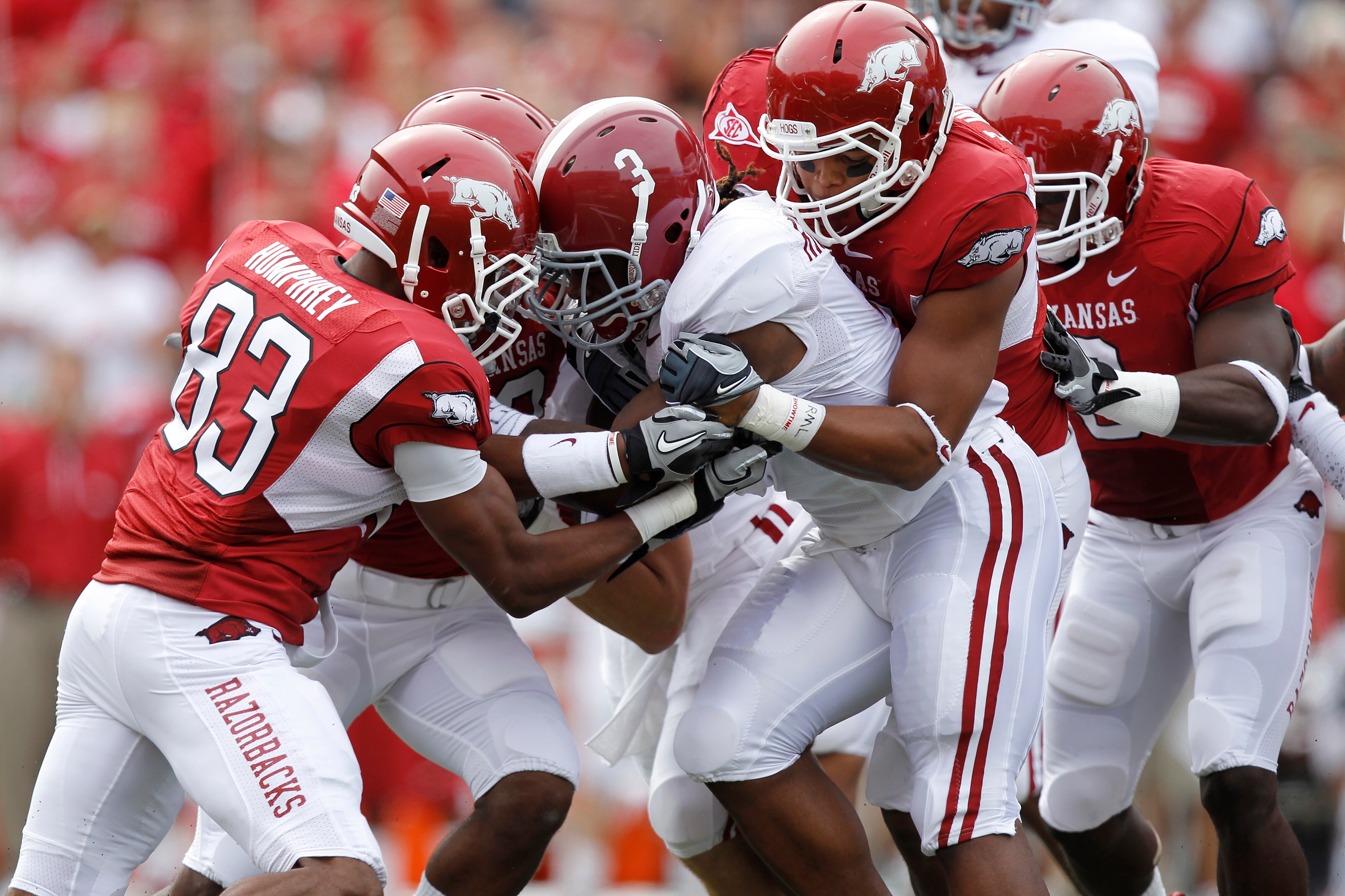 FAYETTEVILLE - SEPTEMBER 25: Trent Richardson #3 of the Alabama Crimson Tide gets tackled by a group of Arkansas Razorbacks defenders during the first half at Donald W. Reynolds Razorback Stadium on September 25, 2010 in Fayetteville, Arkansas. (Photo by