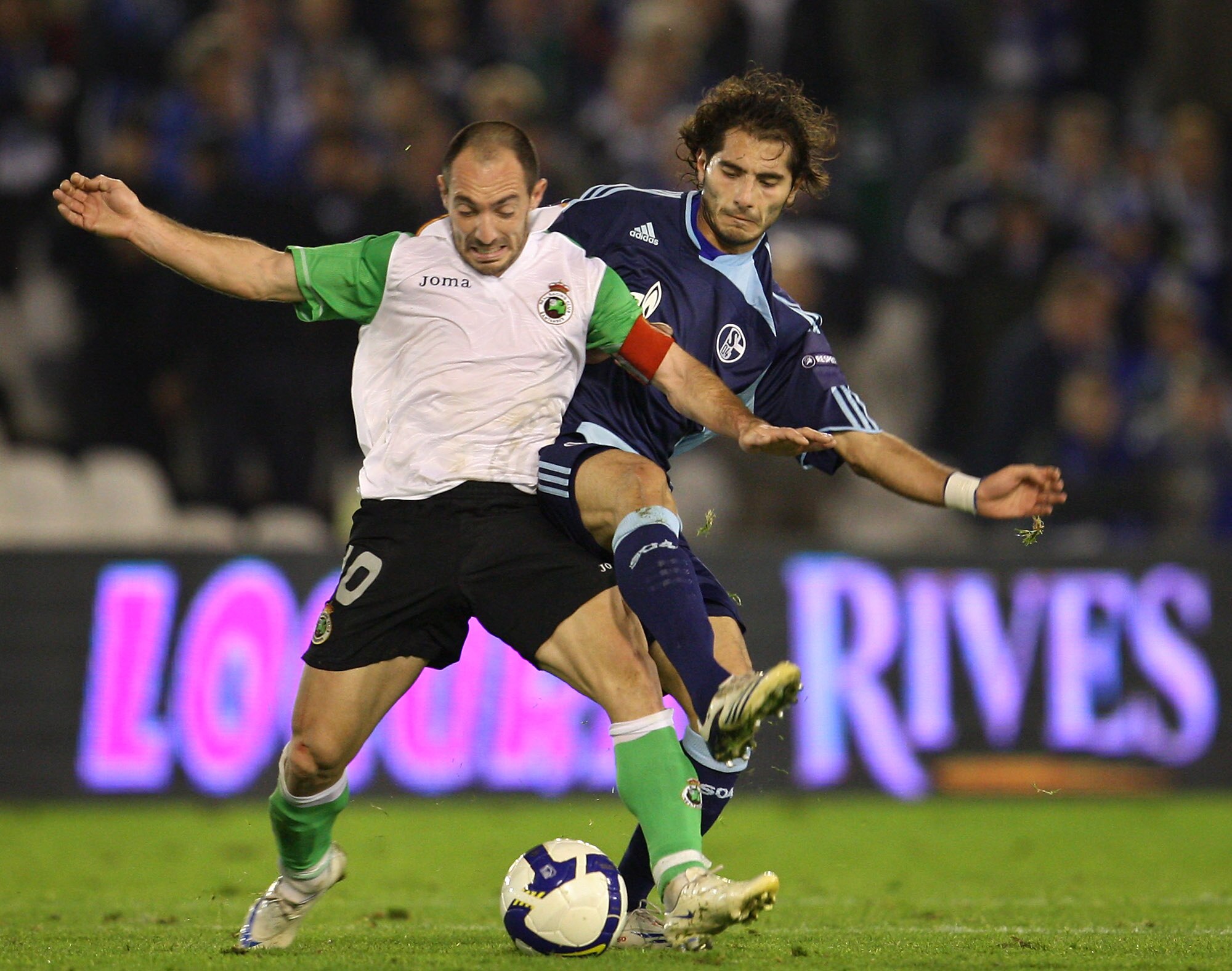 SANTANDER, SPAIN - NOVEMBER 06:  Halil Altintop (R) of Schalke 04 duels for the ball with Pedro Munitis of Racing Santander during the UEFA Cup group A match between Racing Santander and Schalke 04 at the El Sardinero stadium on November 6, 2008 in Santan