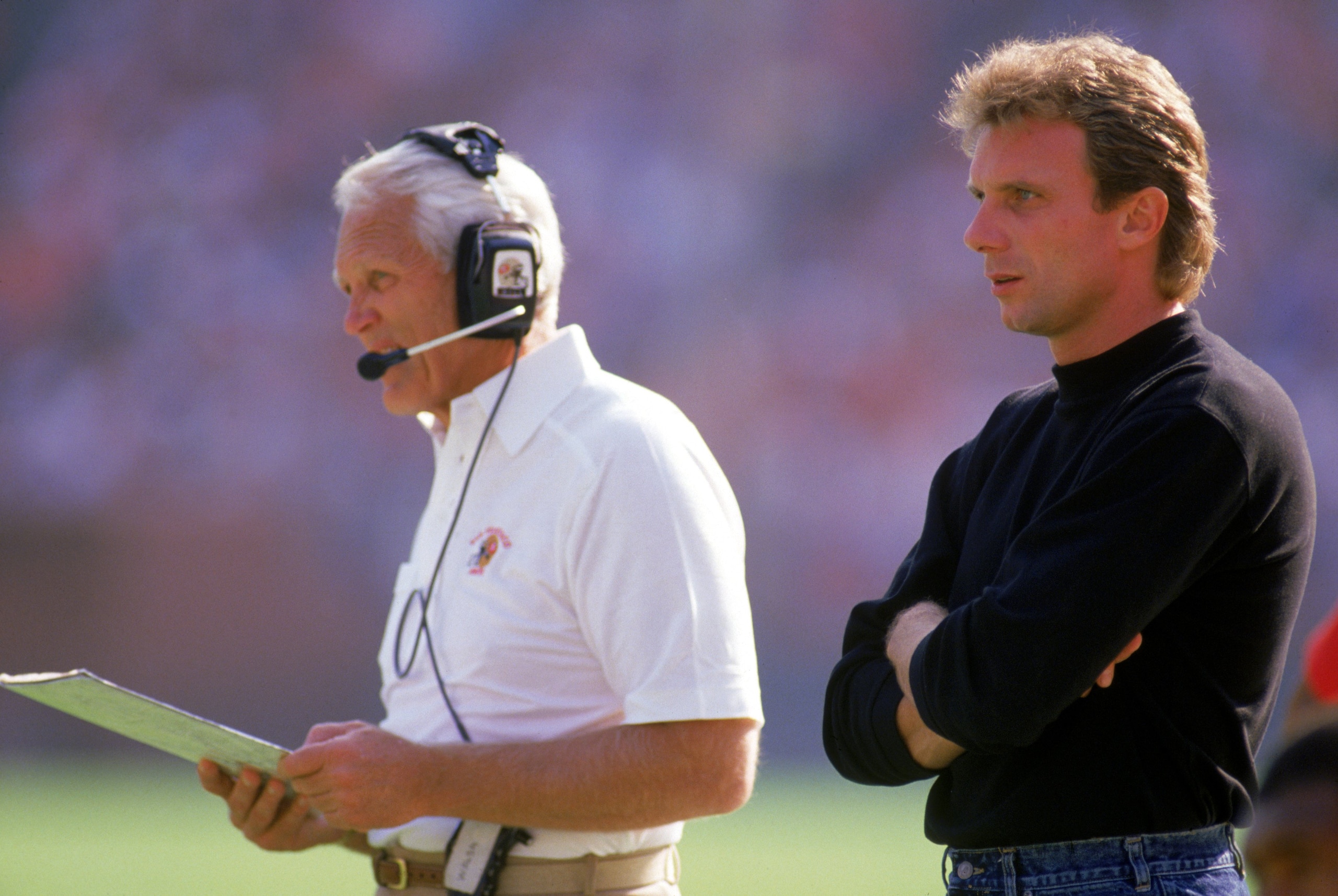 SAN FRANCISCO - OCTOBER 30: Head coach Bill Walsh and injured quarterback Joe Montana #16 of the San Francisco 49ers looks on from the sideline during a game against the Minnesota Vikings at Candlestick Park on October 30, 1988 in San Francisco, Californi