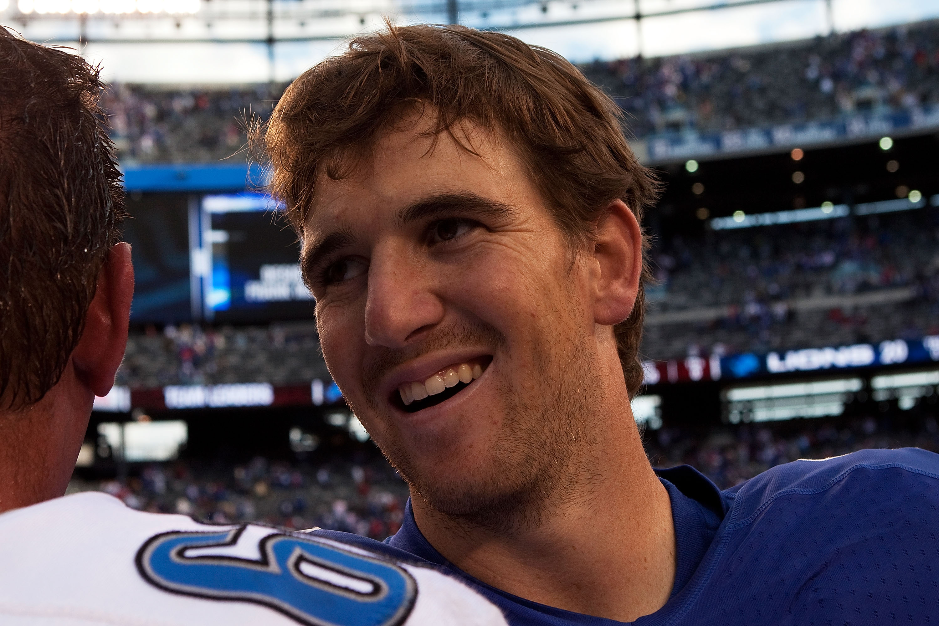 EAST RUTHERFORD, NJ - OCTOBER 17: Eli Manning #10 of the New York Giants smiles after defeating the Detroit Lions 28 - 20 at New Meadowlands Stadium on October 17, 2010 in East Rutherford, New Jersey.  (Photo by Andrew Burton/Getty Images)