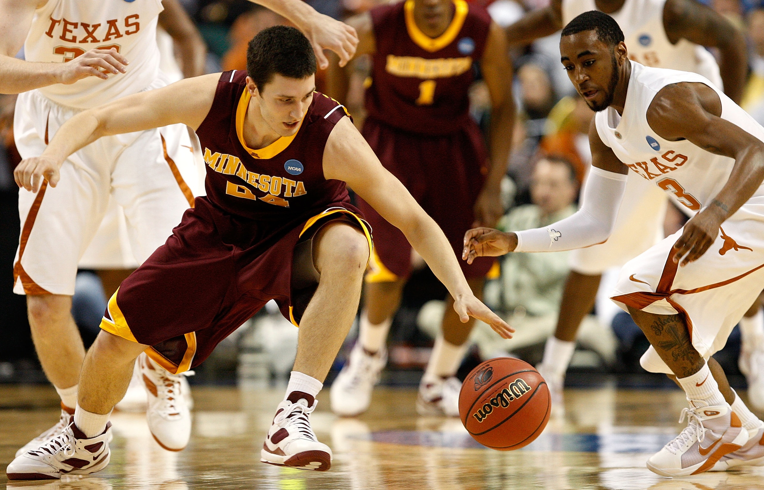 GREENSBORO, NC - MARCH 19:  Blake Hoffarber #24 of the Minnesota Golden Gophers recovers a loose ball against A.J. Abrams #3 of the Texas Longhorns during the first round of the NCAA Division I Men's Basketball Tournament at the Greensboro Coliseum on Mar
