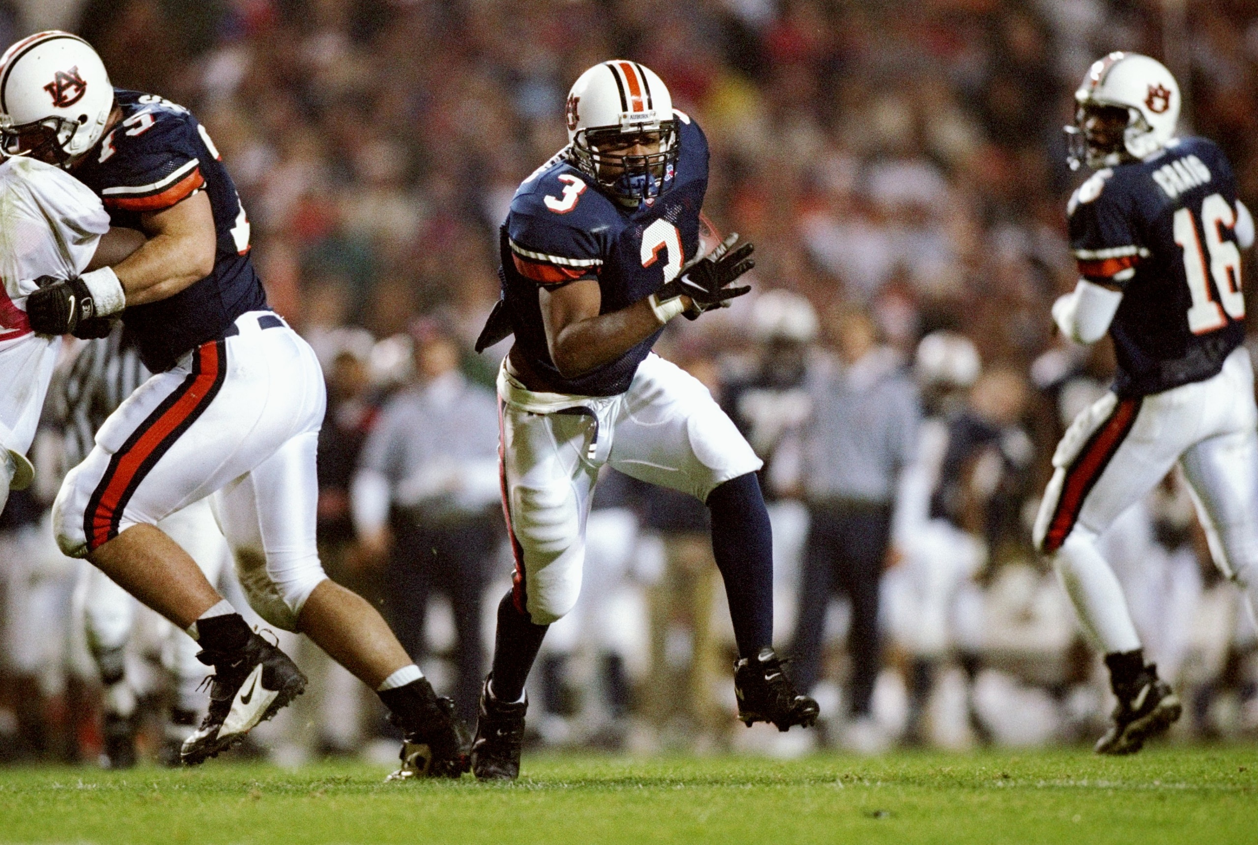 22 Nov 1997:  Tailback Rusty Williams of the Auburn Tigers (center) runs past quarterback Dameyune Craig (right) during a game against the Alabama Crimson Tide at the Jordan-Hare Stadium in Auburn, Alabama.  Auburn won the game 18-17. Mandatory Credit: An